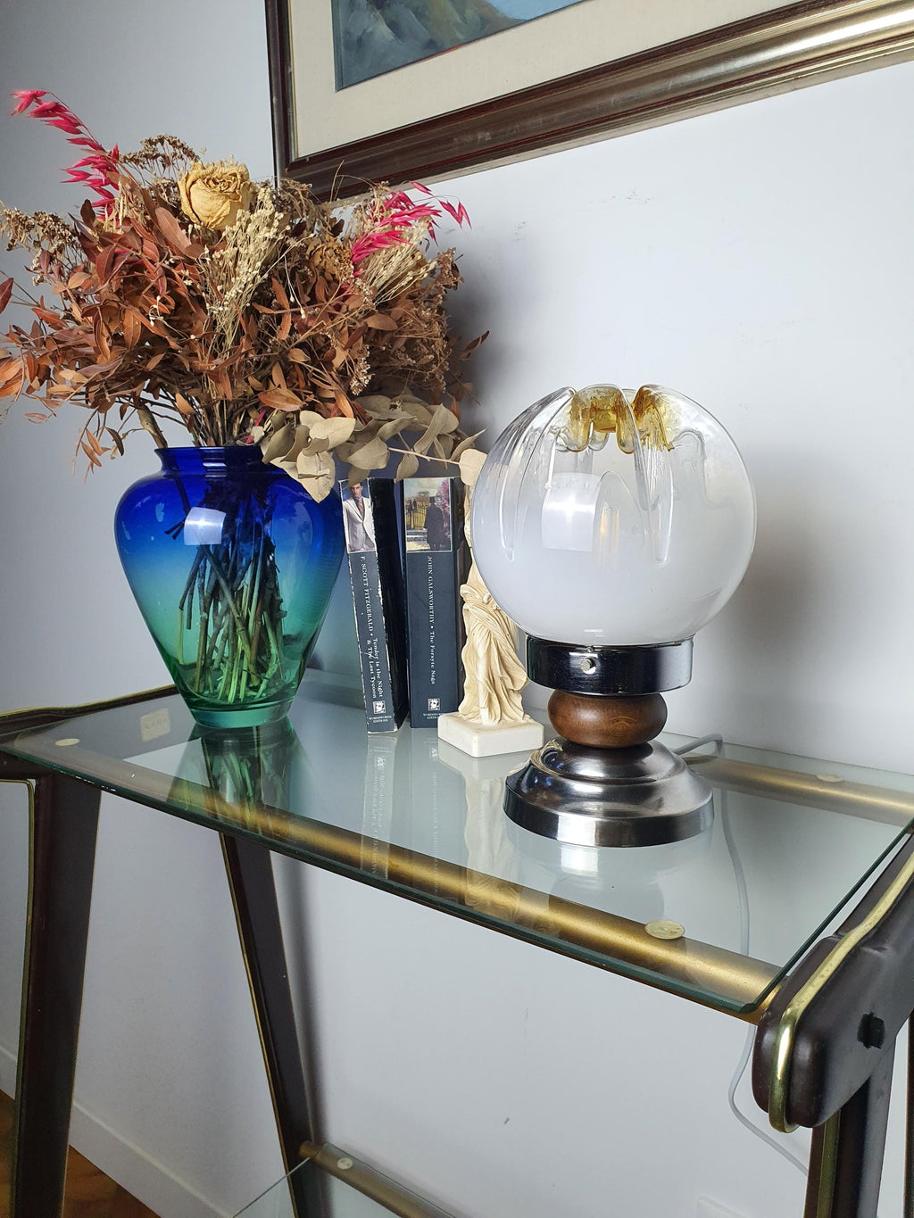 Wood and chrome base detail on vintage Mazzega Murano glass table lamp, warm natural wood and reflective chrome contrast
