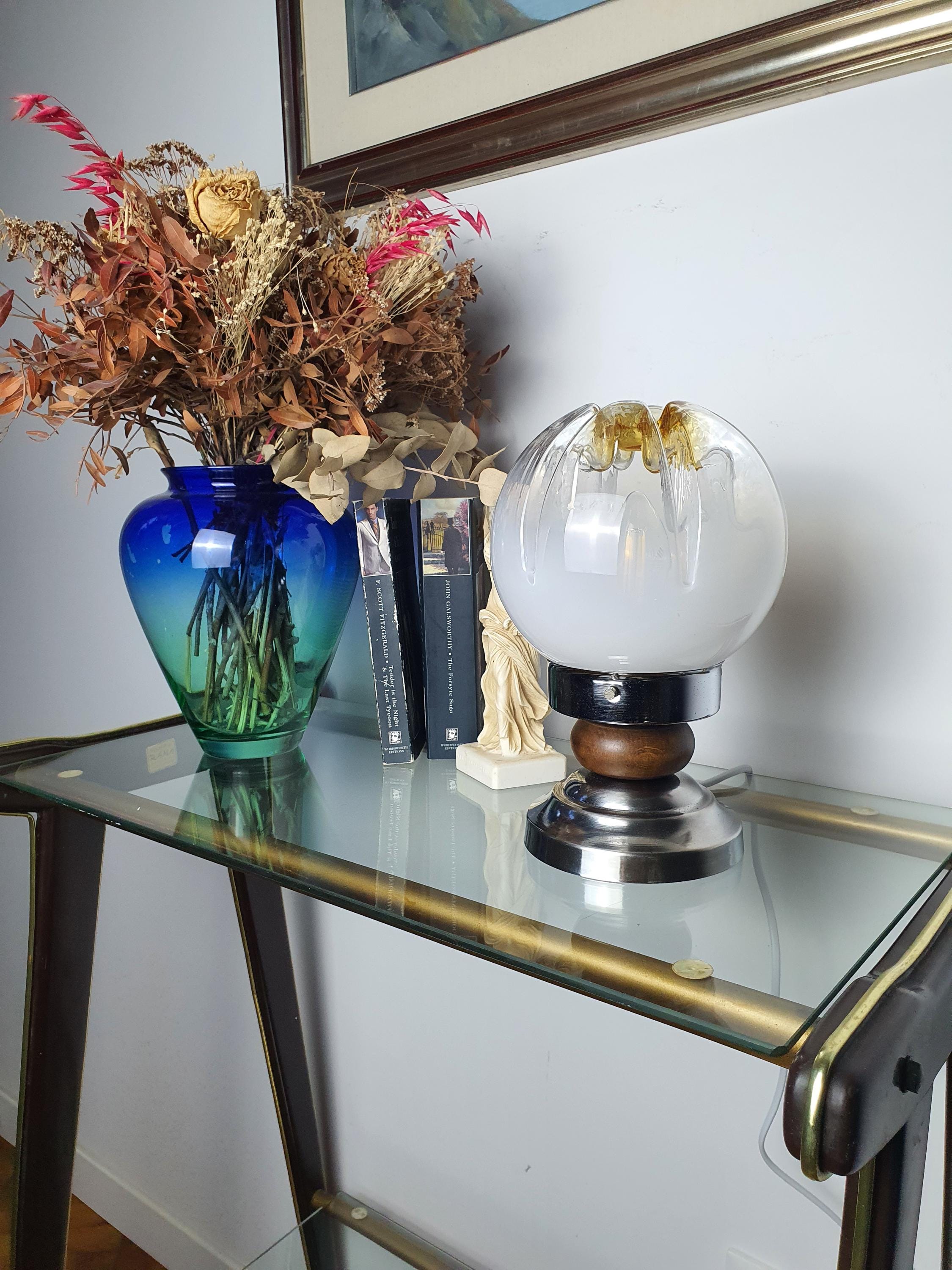 Wood and chrome base detail on vintage Mazzega Murano glass table lamp, warm natural wood and reflective chrome contrast