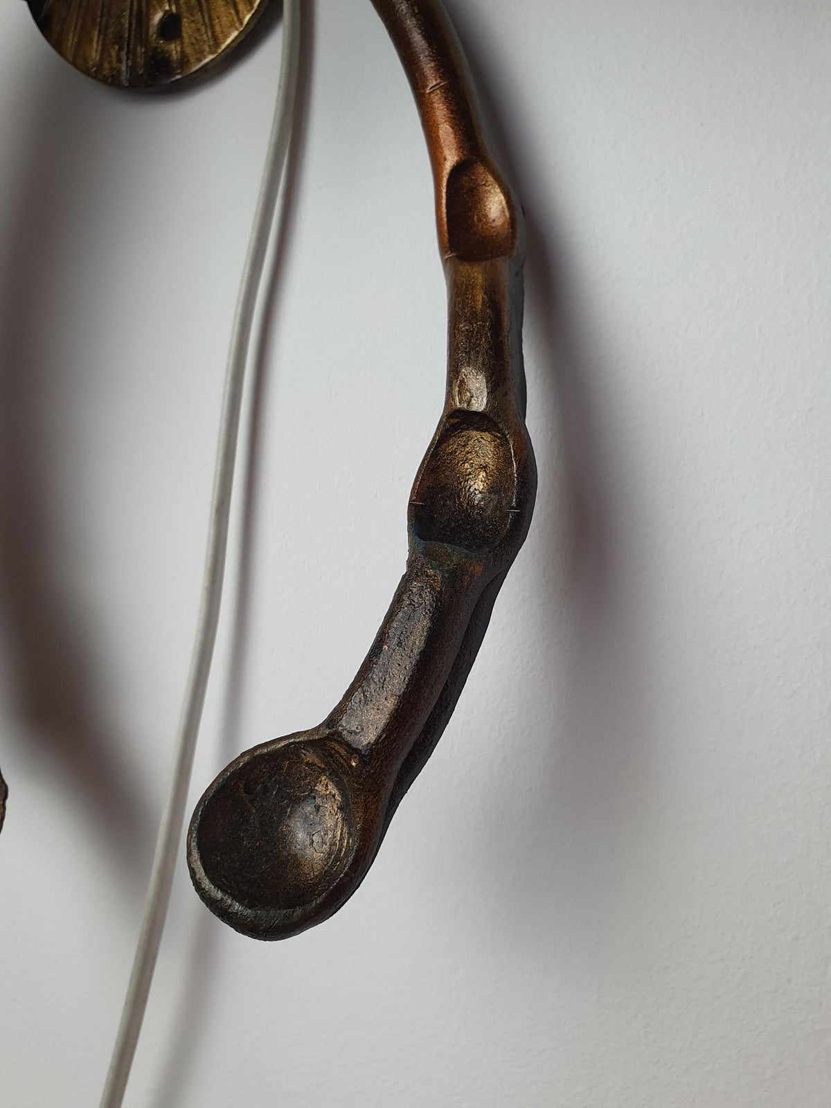 Hand-painted details on a vintage bronze and gilded metal light
