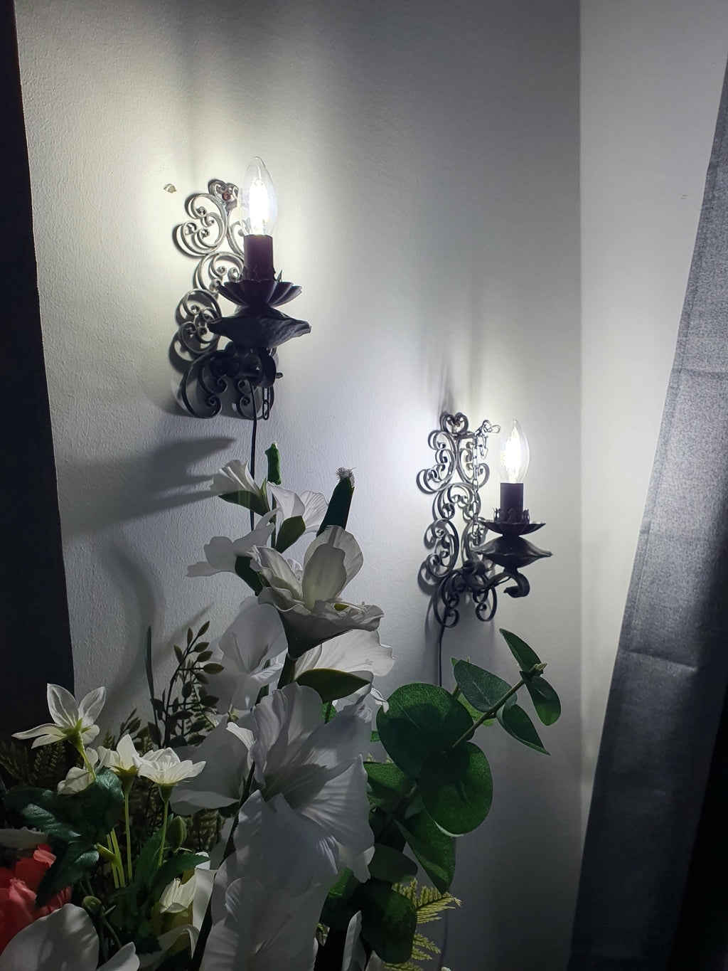 Pair of gothic wall lights — both sconces shown together, stone interior setting