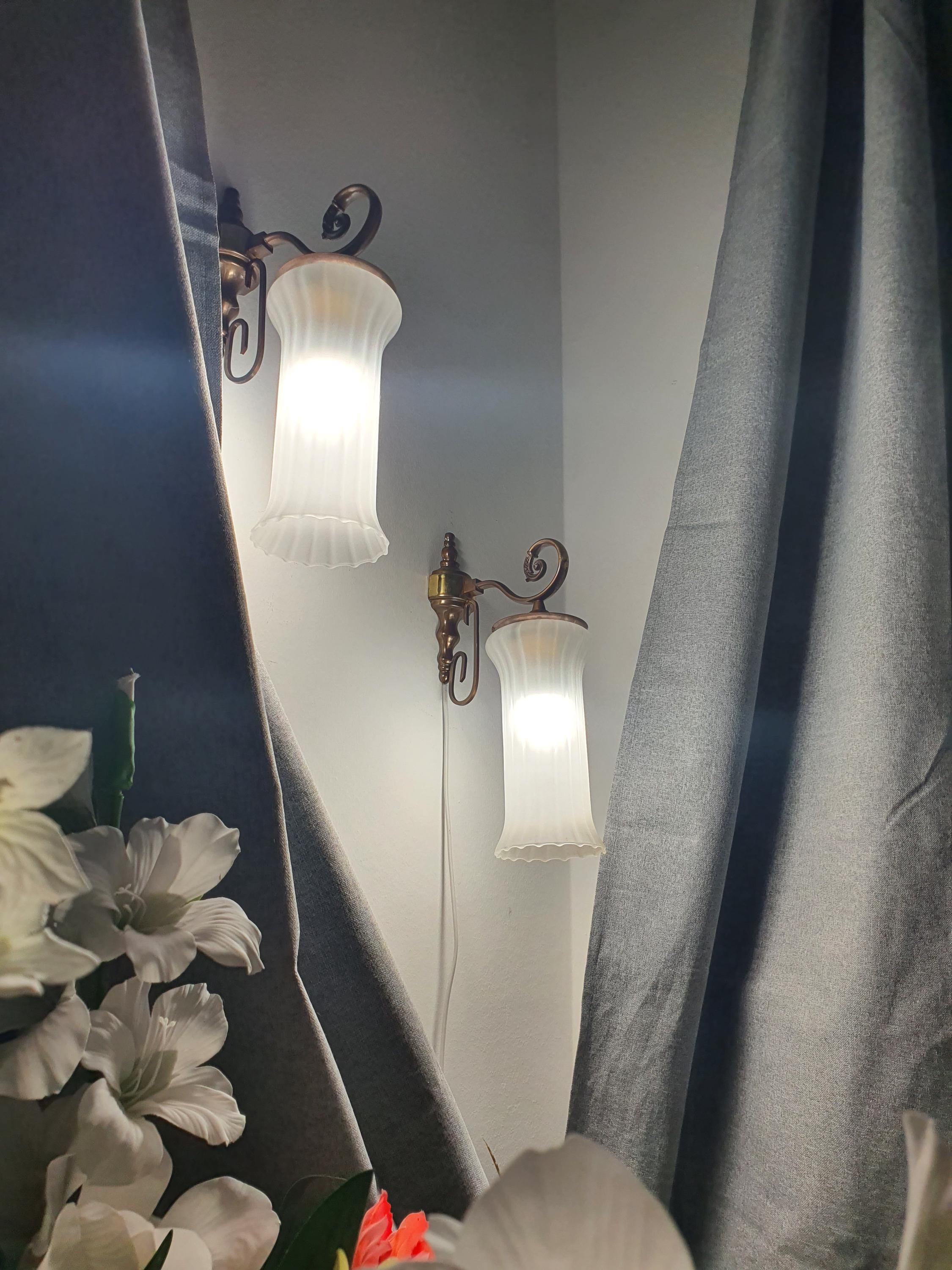 Vintage Italian satin frosted flute wall sconce in bathroom, elongated flute form, brass base, soft ambient light
