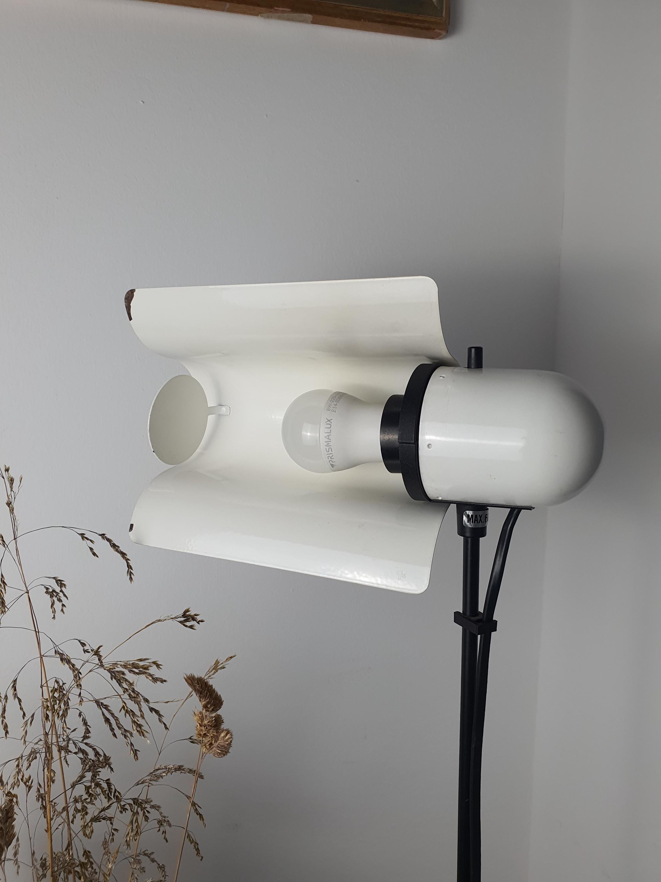 Vintage Italian white floor lamp unlit, showing swing visor silhouette, U-shaped arm, and telescopic stem