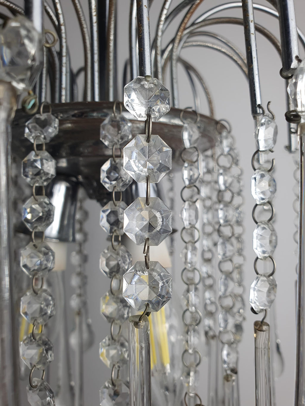 Close-up of clear faceted Murano glass teardrop pendants on vintage cascade chandelier, sparkling crystalline clarity