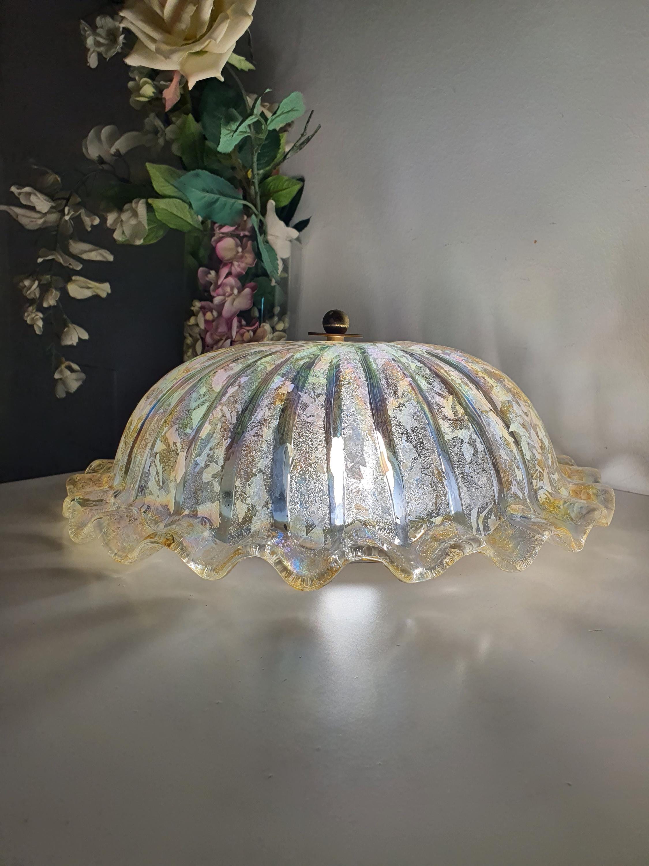 Vintage Murano iridescent shell ceiling light lit, oil-on-water rainbow reflections, atmospheric glow, organic interior