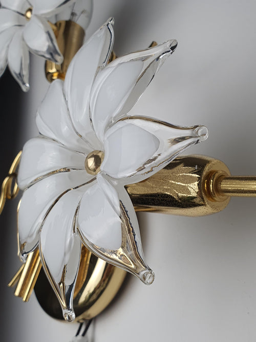 Close-up of white milky Murano glass flower shade on vintage Italian floral wall sconce, soft petal diffusion, gold metal detail