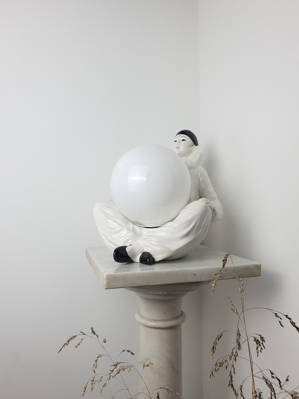 Vintage Italian Pierrot clown ceramic lamp side profile, showing 20cm depth, sad clown figurine base and white globe shade