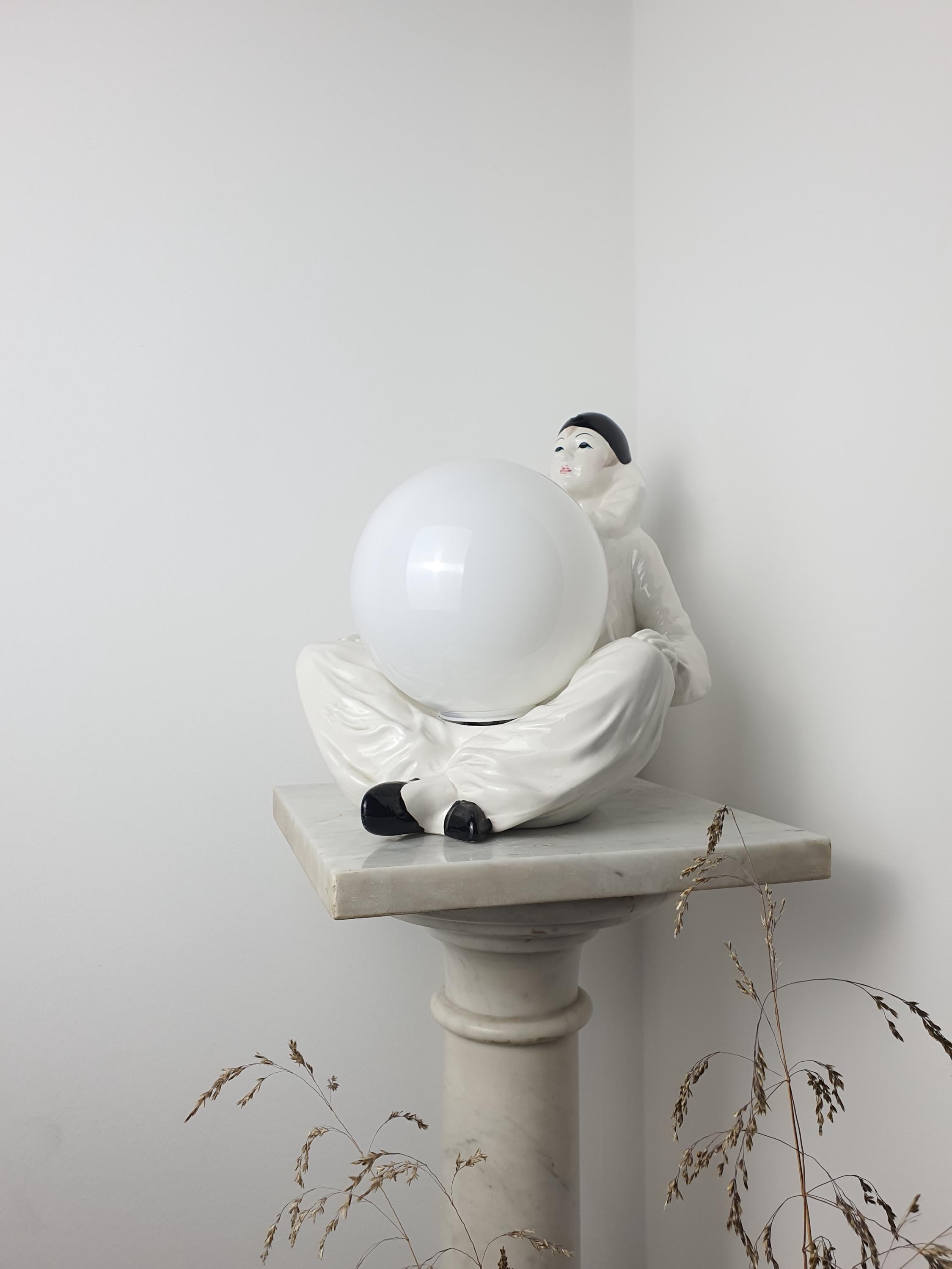 Vintage Italian Pierrot clown ceramic lamp side profile, showing 20cm depth, sad clown figurine base and white globe shade