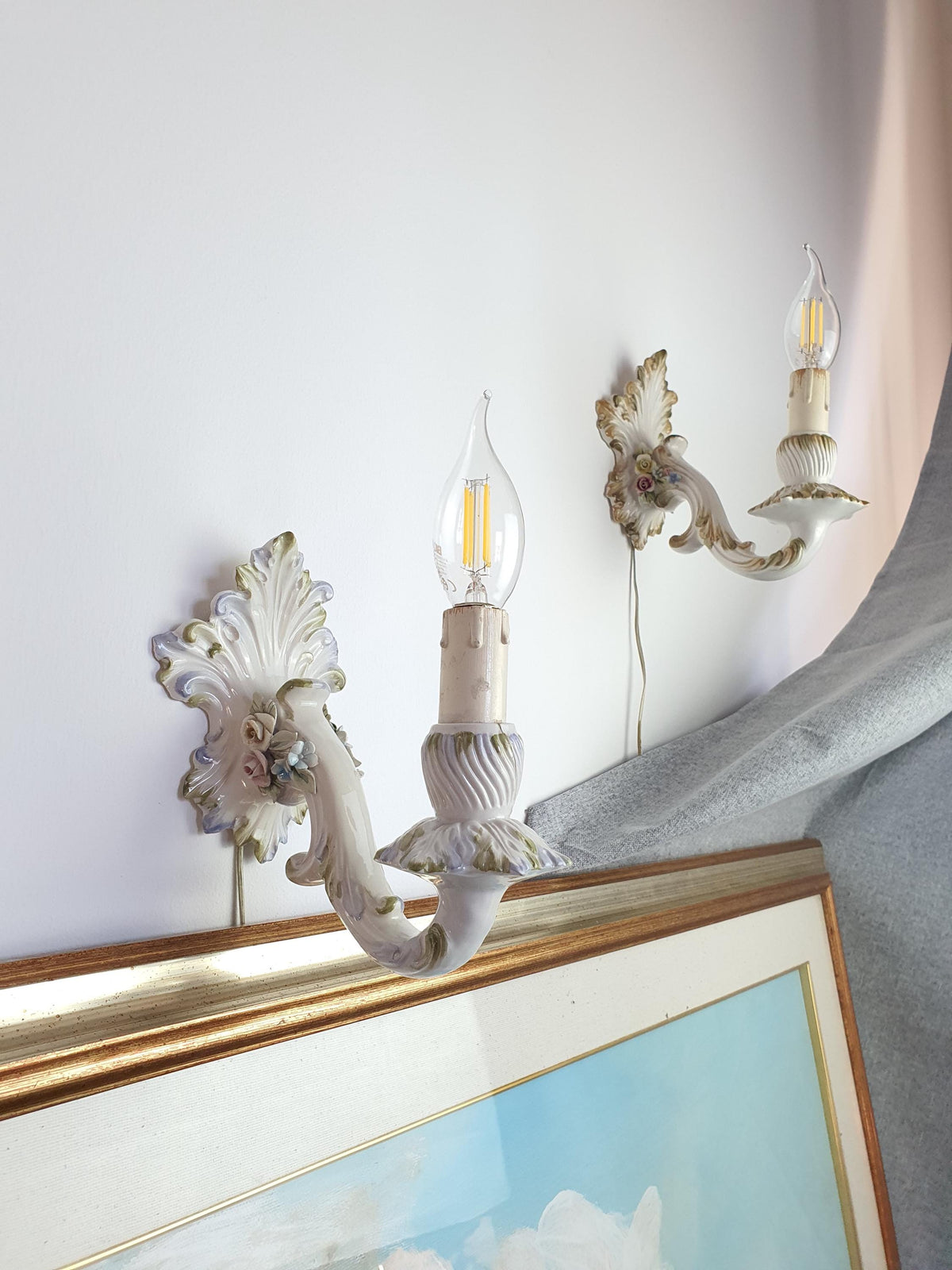 Handcrafted porcelain flowers decorating a vintage Italian wall sconce
