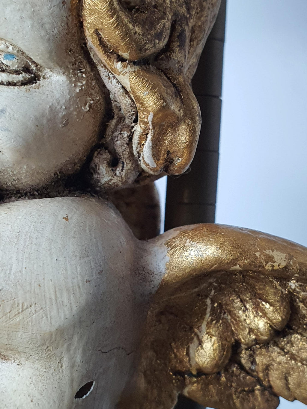 Close-up of hand-painted cherub angel face and gold accents, vintage Italian Florentine table lamp
