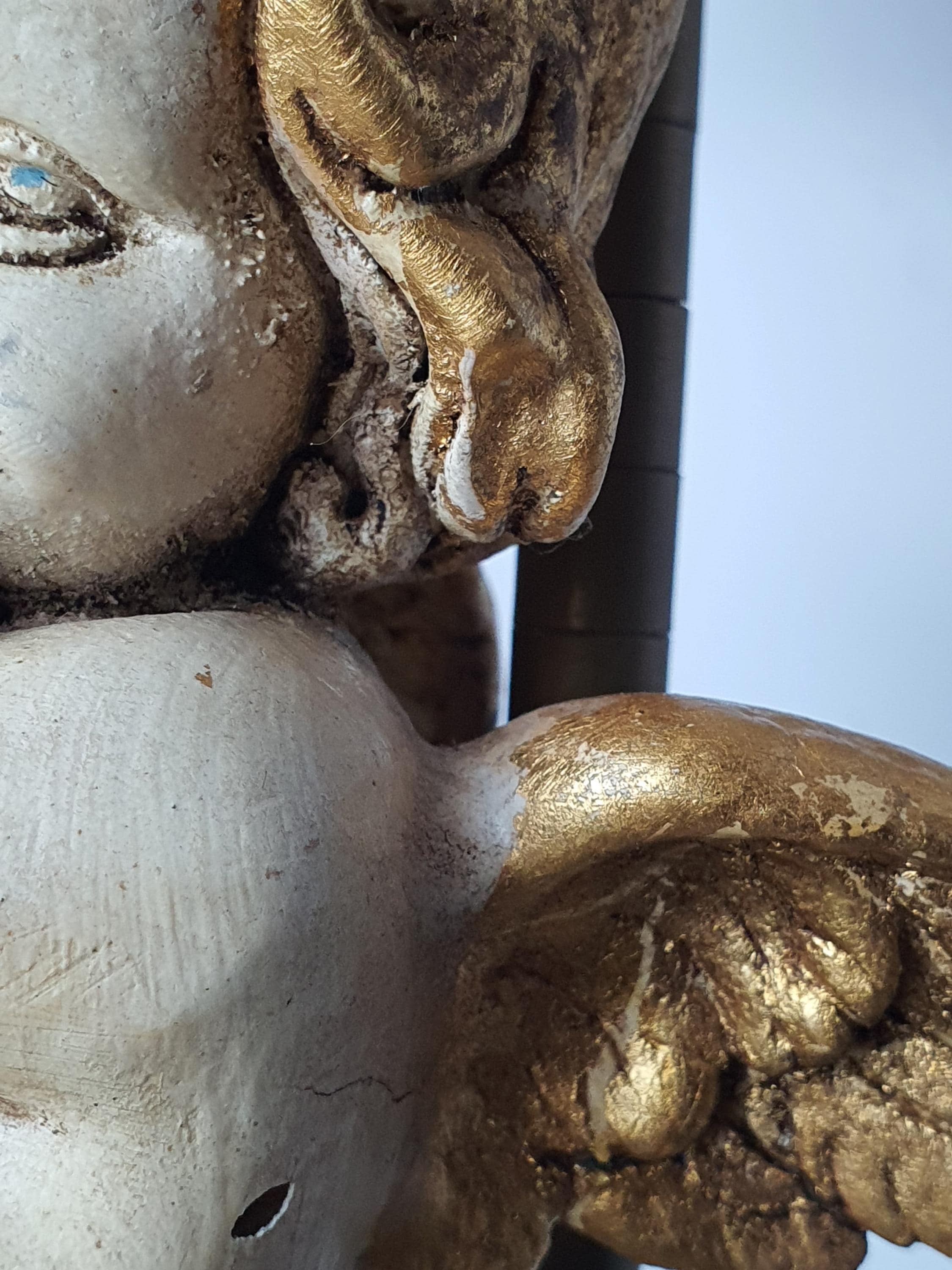Close-up of hand-painted cherub angel face and gold accents, vintage Italian Florentine table lamp