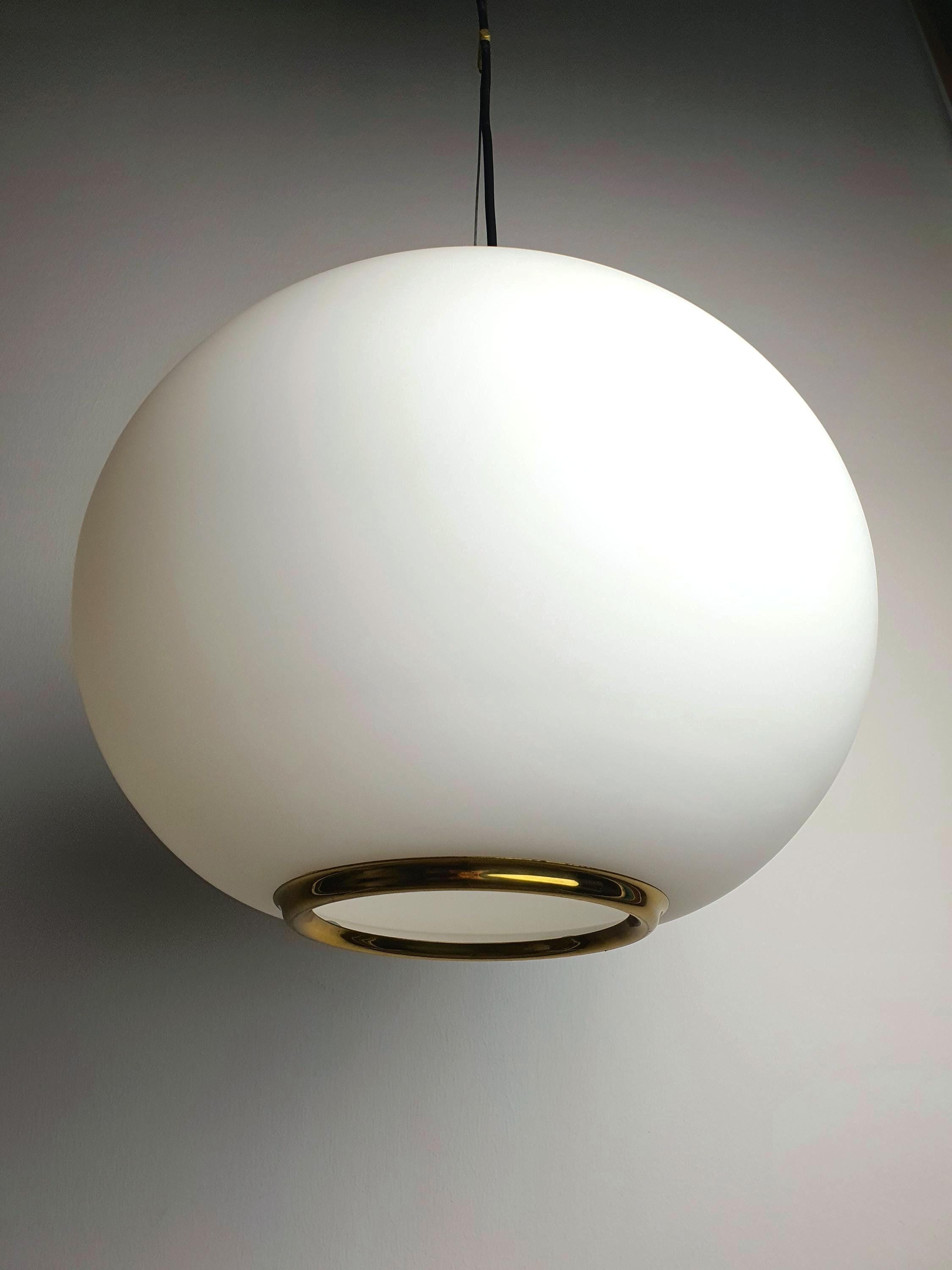 Satin glass globe pendant light in brass frame