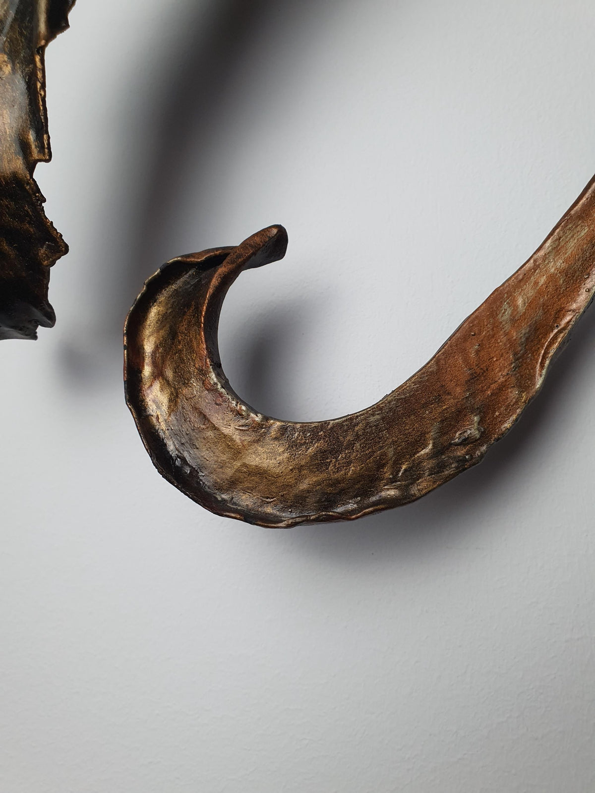 Hand-shaped metal leaves and organic curves on a vintage botanical fixture
