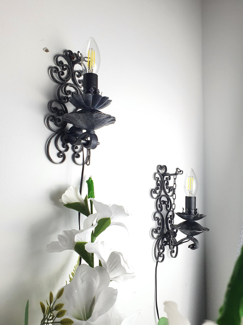 Handcrafted gothic wall sconce — artisanal metalwork texture and depth, close-up