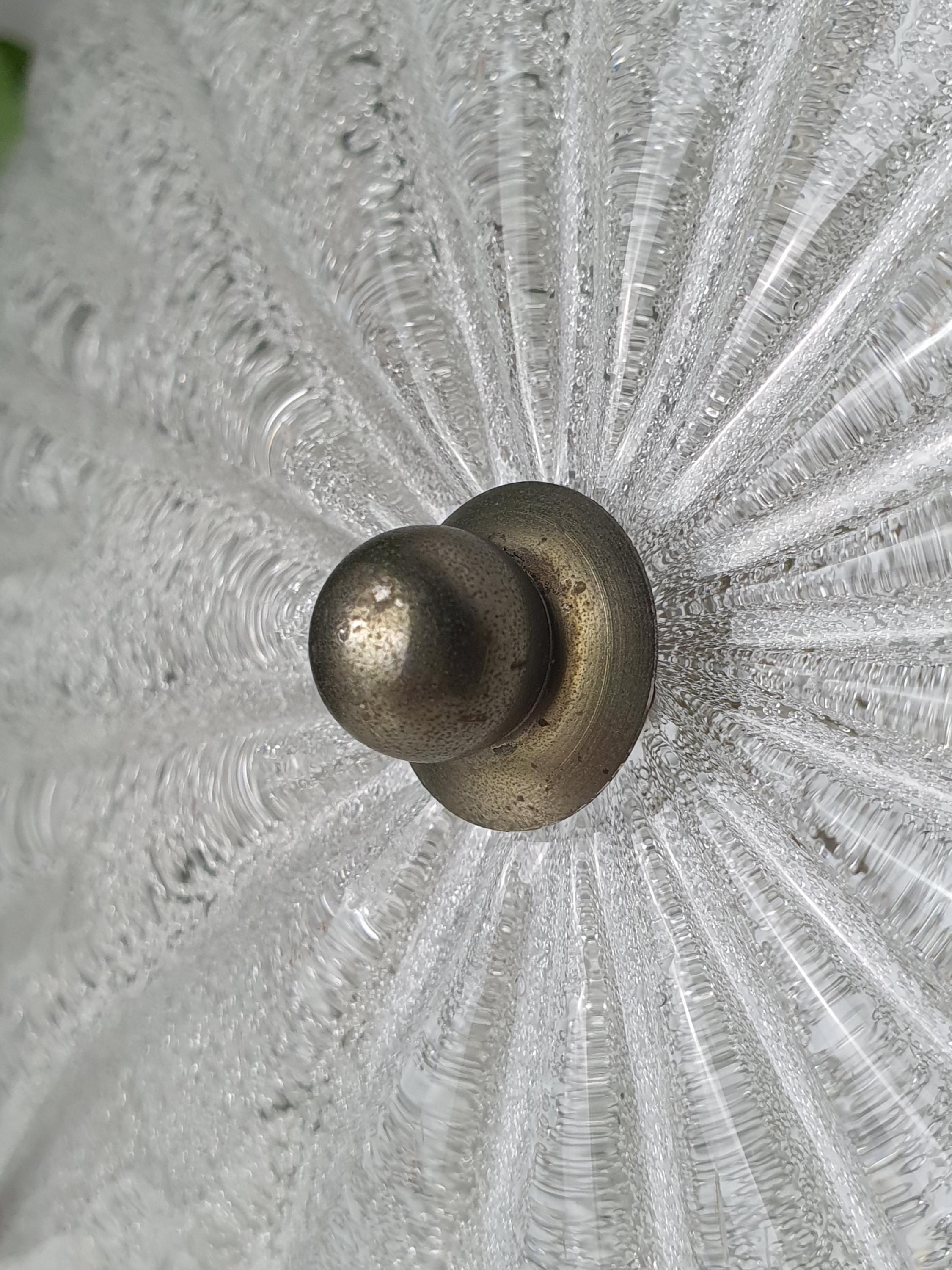 Close-up of thick ribbed clear glass and ghiacciato iced texture on vintage Murano shell flush mount, light reflections