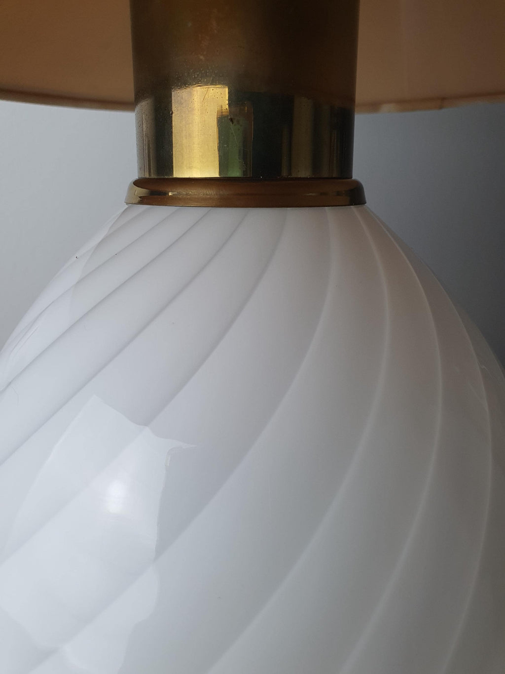 Vintage Murano white candy swirl bedside lamp in guest room, soft beige shade glow, brass base, romantic MCM interior