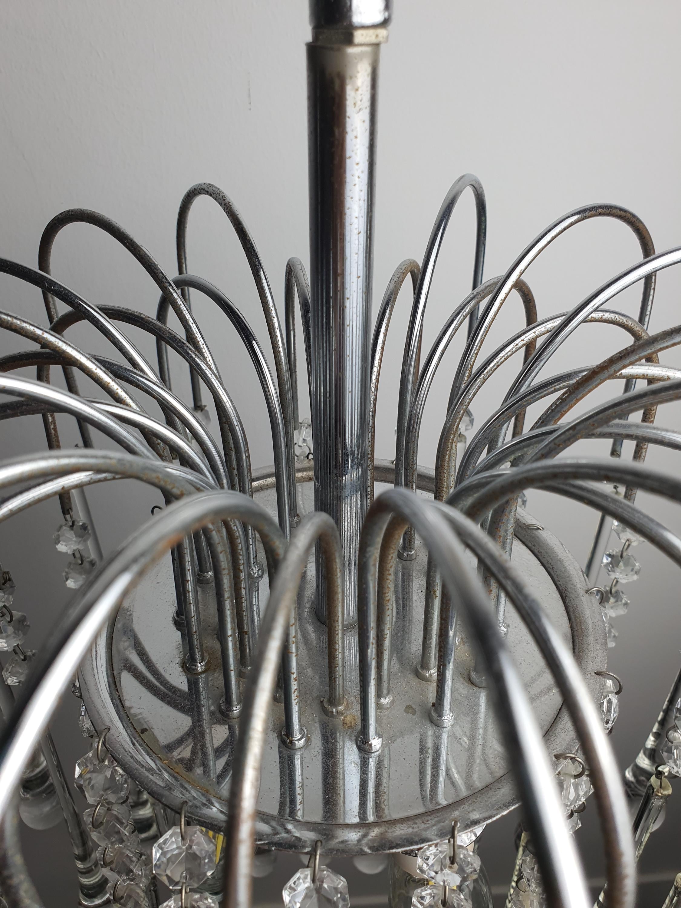 Chrome frame detail with oxidation on vintage Murano clear teardrop cascade chandelier, authentic vintage character