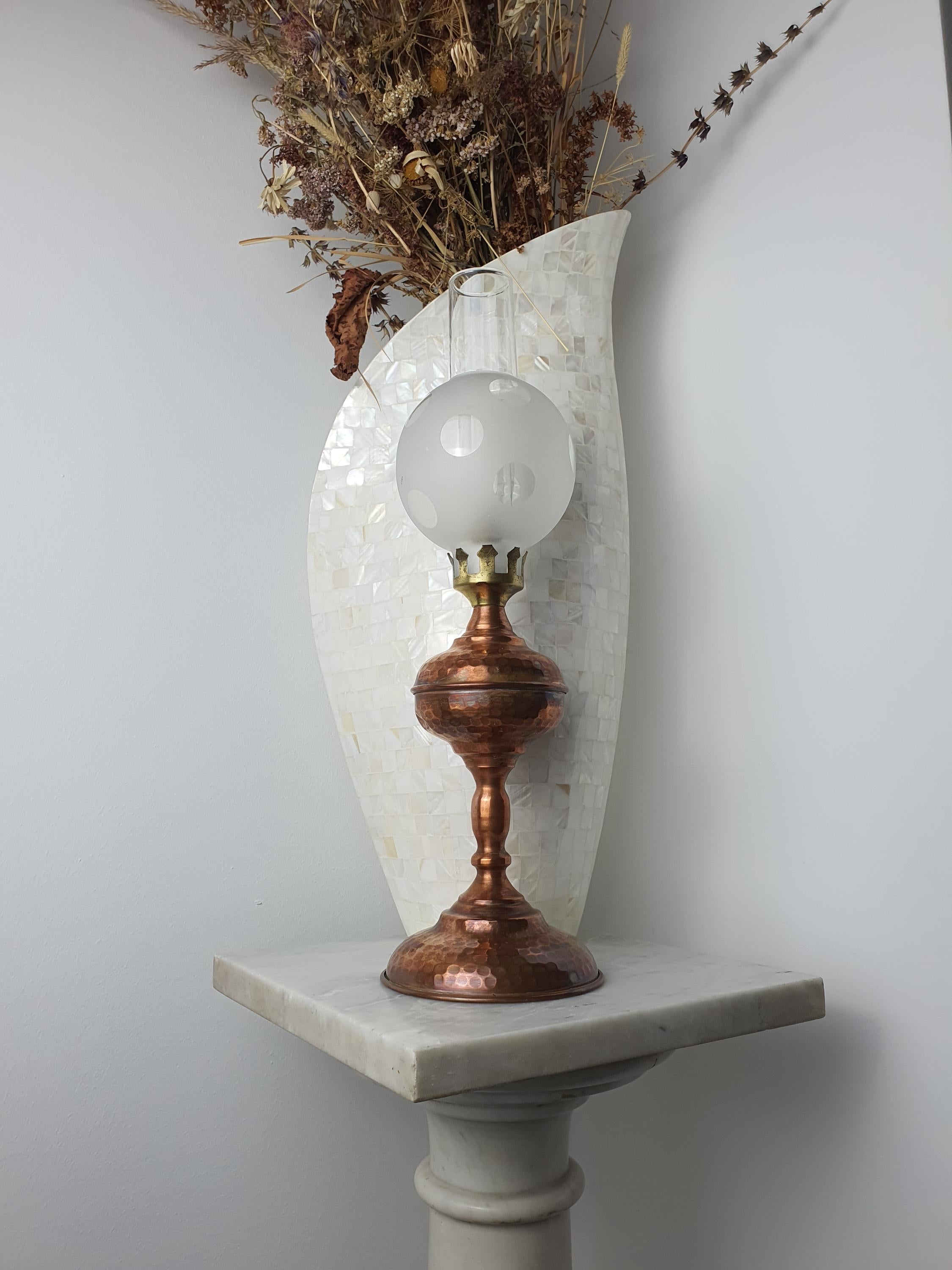 Vintage 1950s Italian copper oil lamp on bedside table, warm spotted glass glow, cottage romantic vintage bedroom