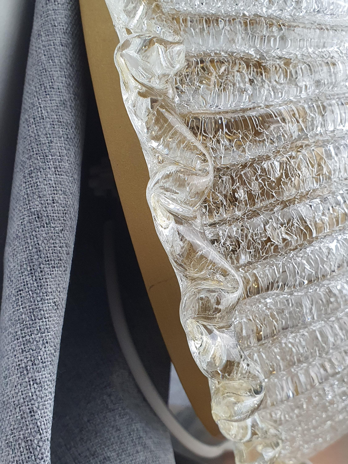 Gold avventurina inclusions along the edge of a vintage glass shade

