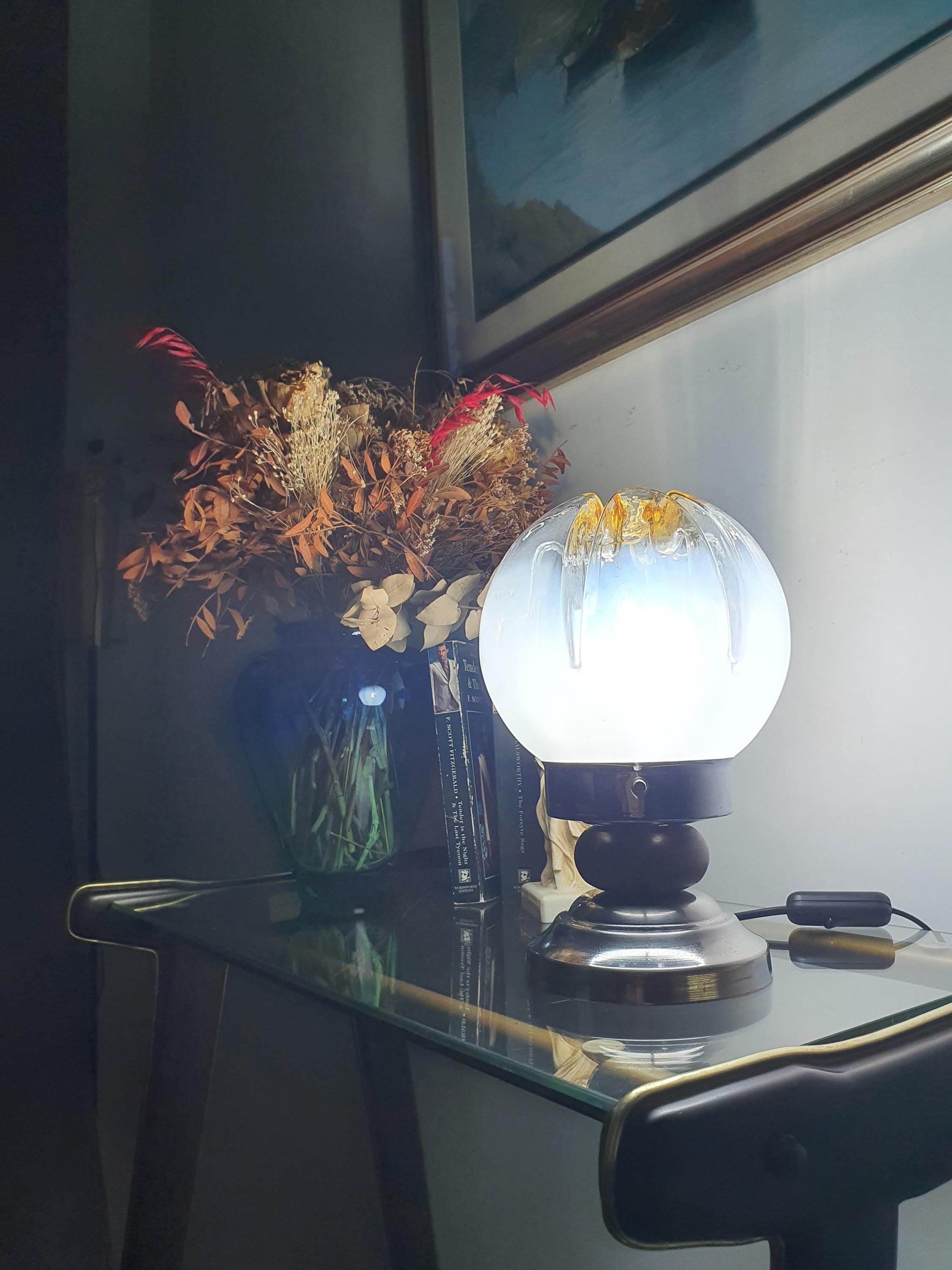 Vintage Mazzega Murano table lamp unlit, showing white-to-clear gradient globe, amber crown and caramel drip relief
