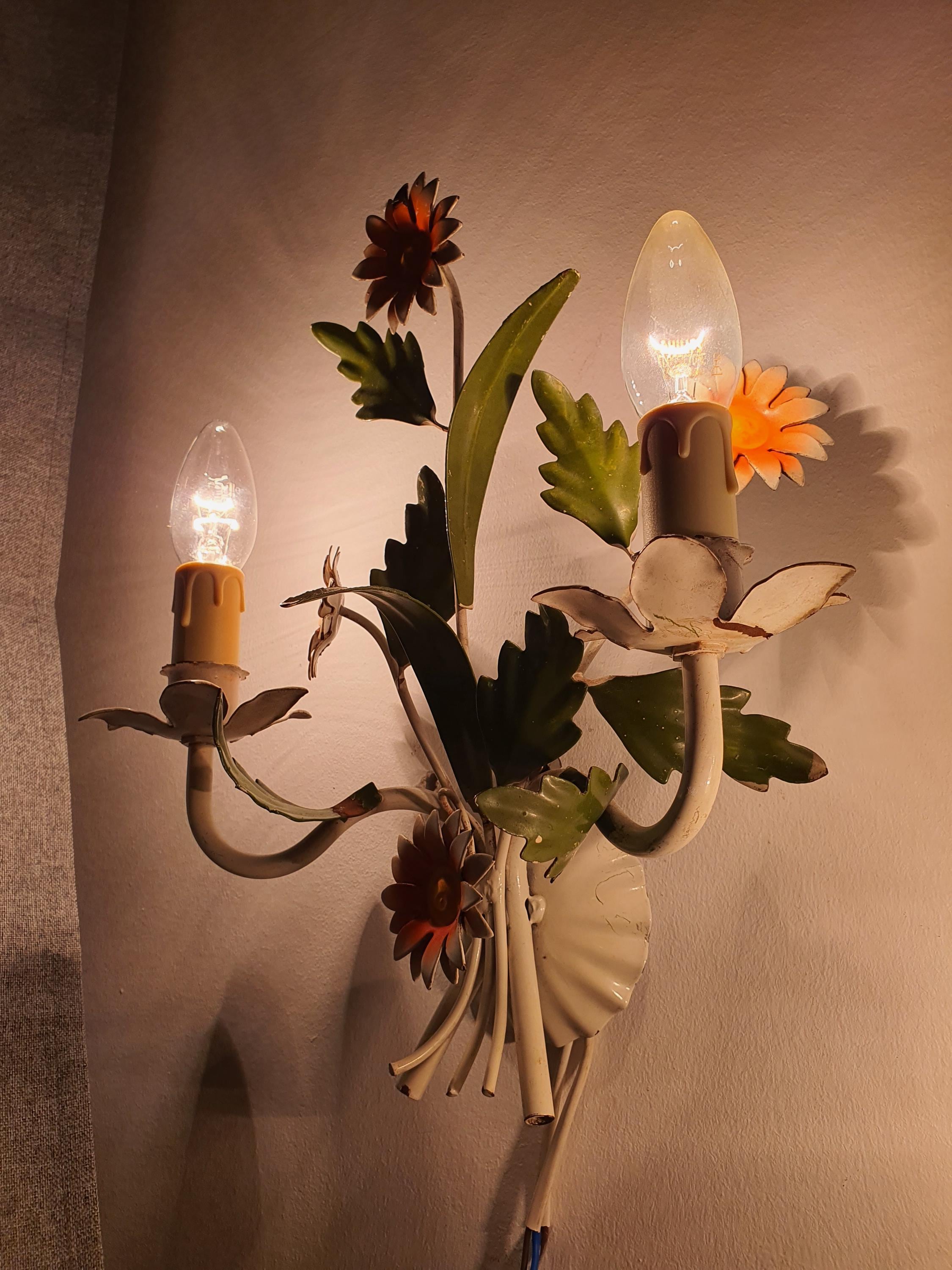Pair of vintage 1970s Italian tole wall sconces in living room, white green orange floral, Bohemian Cottagecore interior