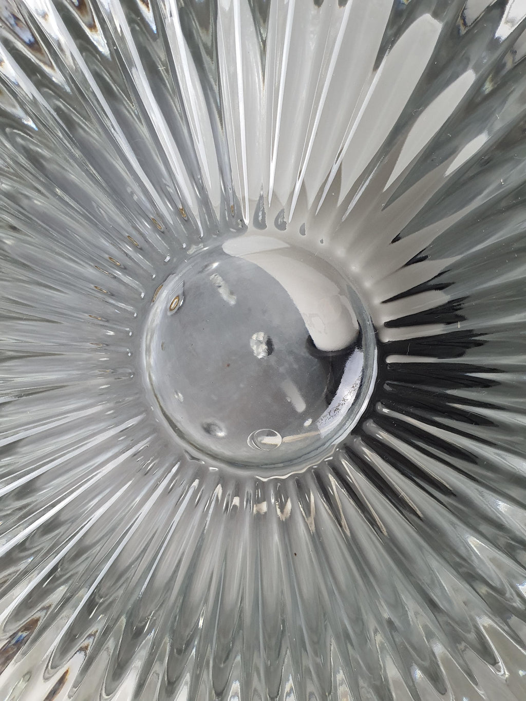 Textured transparent glass contrasting with a silver-tone mounting base
