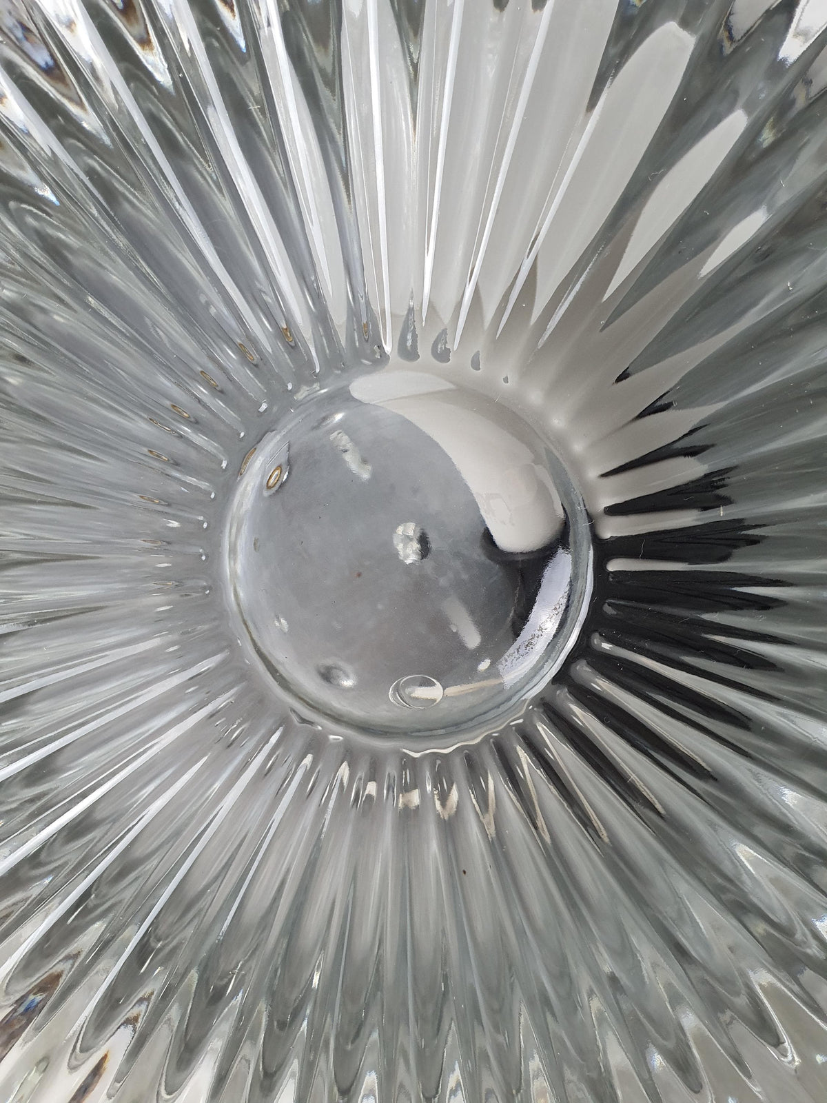 Textured transparent glass contrasting with a silver-tone mounting base
