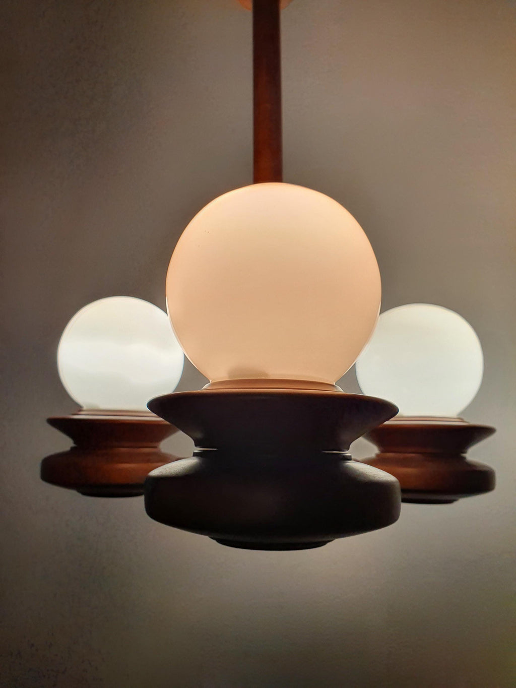 Vintage Space Age Sputnik chandelier front view, three milk glass globe shades, solid wood structure, 41cm diameter