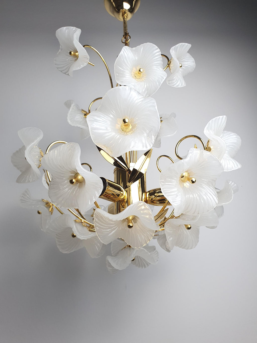Vintage Murano white flower bouquet chandelier in dressing room, soft white bouquet glow, gold frame, intimate glamorous