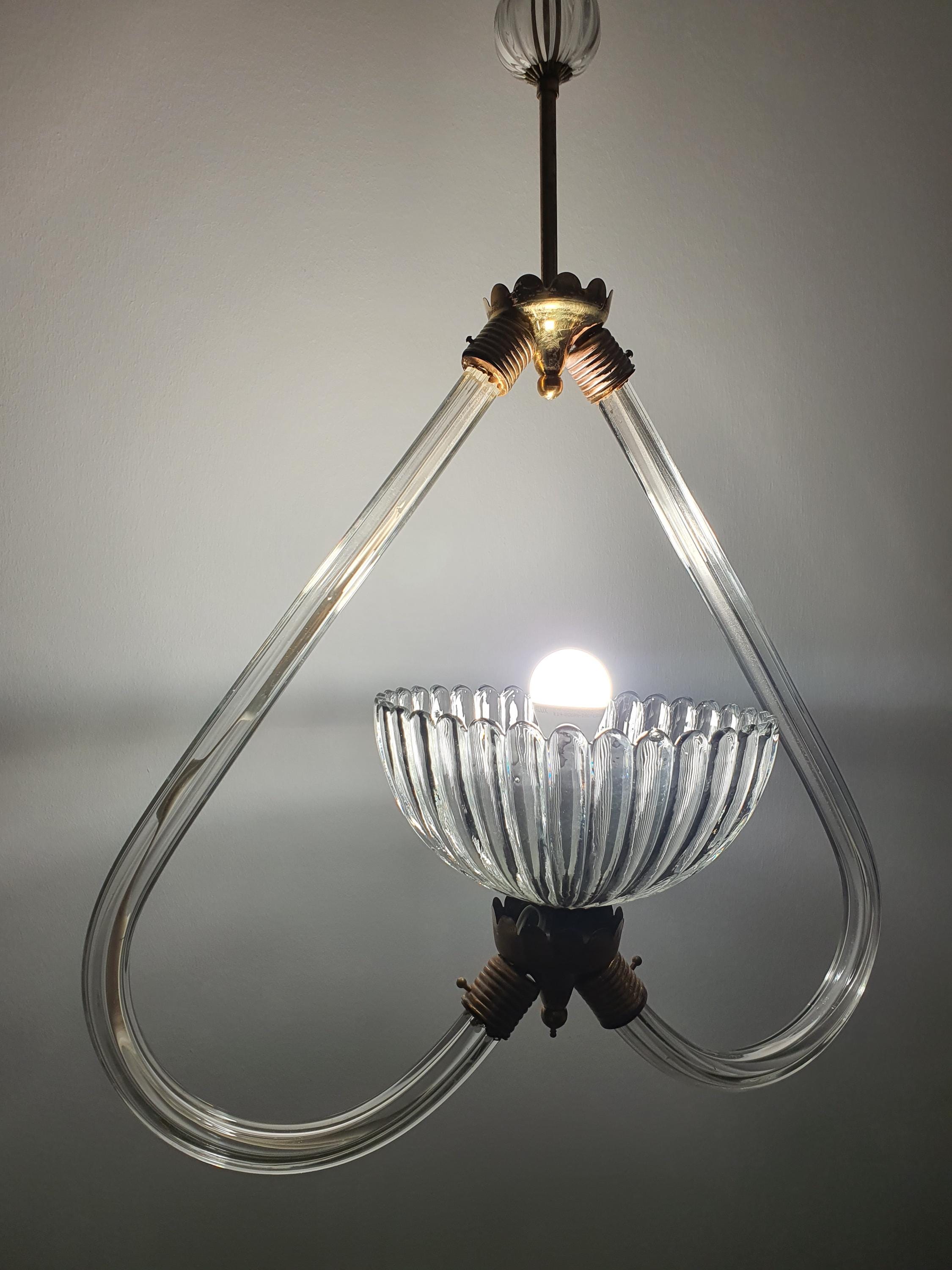 Vintage Murano glass pendant — illuminated, soft warm glow through clear heart-form glass