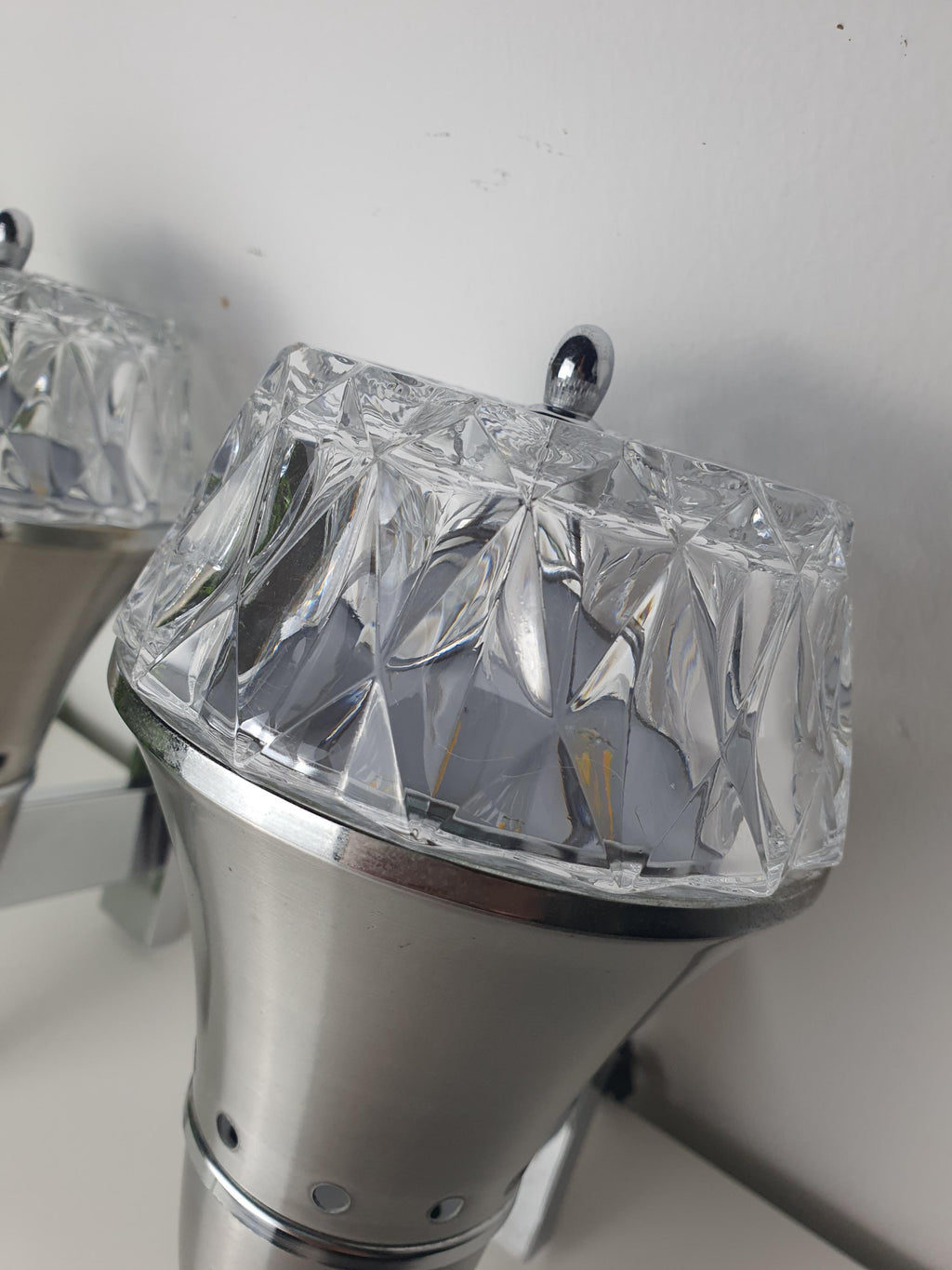 Brutalist Space Age wall sconce — silver-toned metal structure and chrome detail