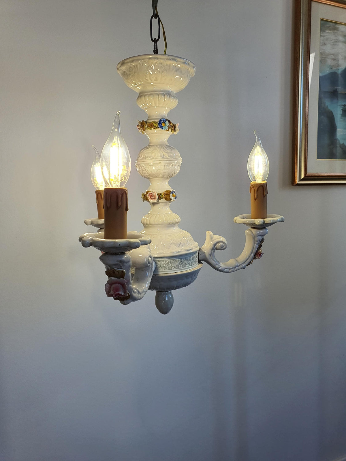 Age-related wear and small imperfections on the chandelier’s ceramic structure

