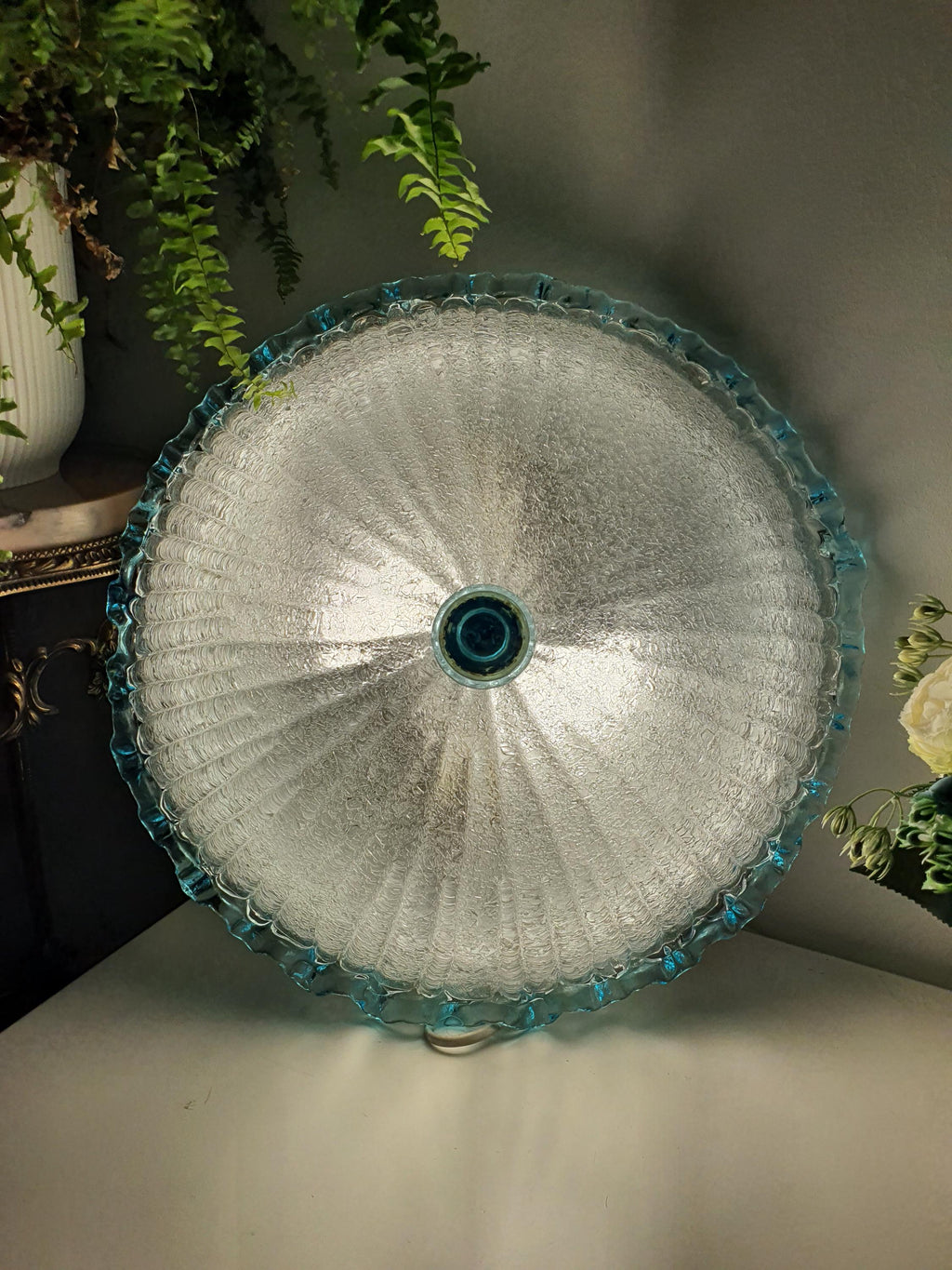 Layered floral glass design with a frosted appearance and pale blue edge
