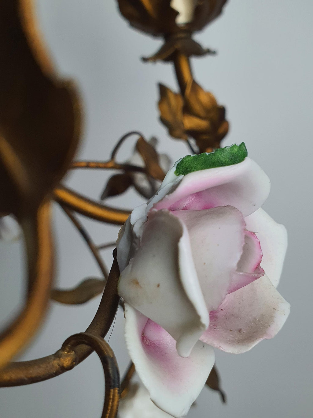Detail of handcrafted porcelain roses on an Italian floral chandelier
