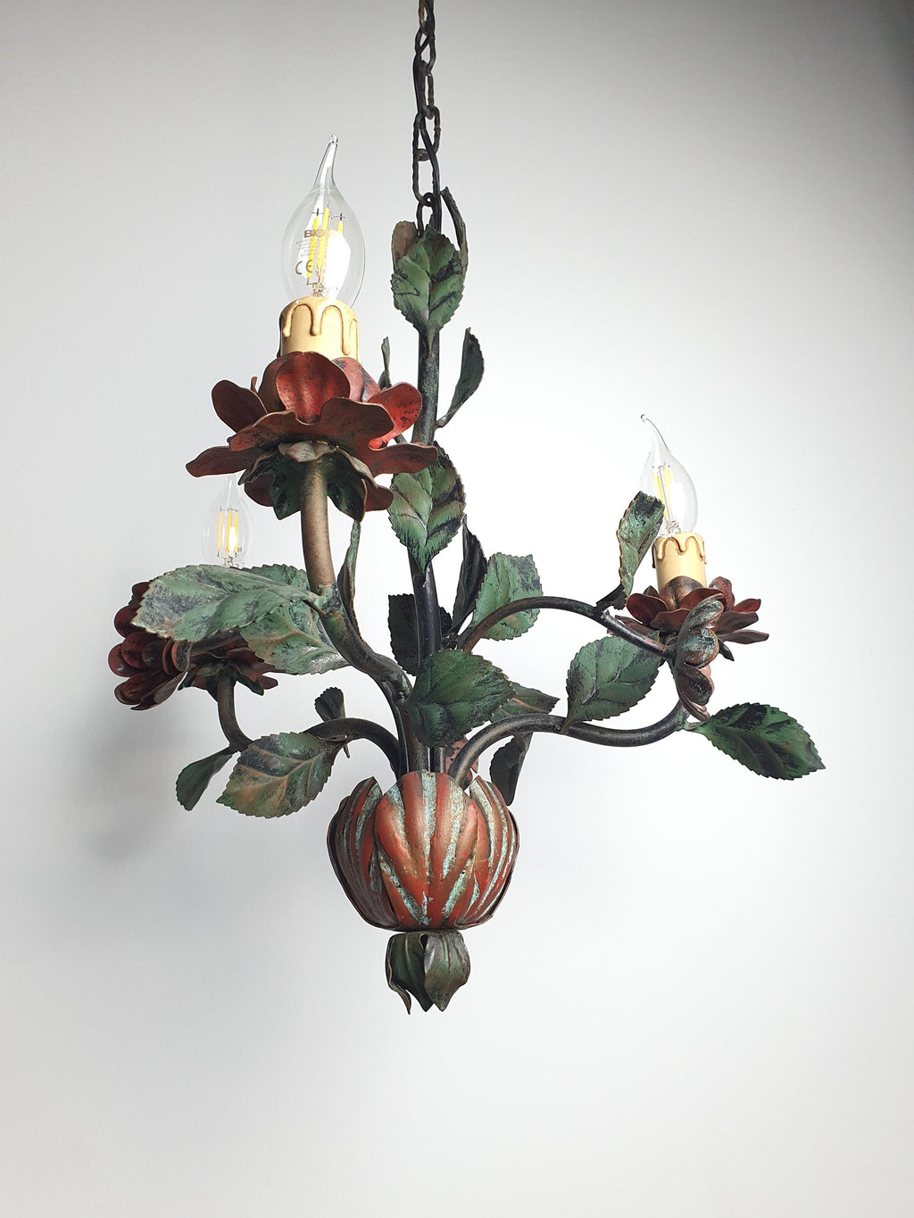 Red poppy- and rose-inspired metal flowers on a vintage Italian chandelier
