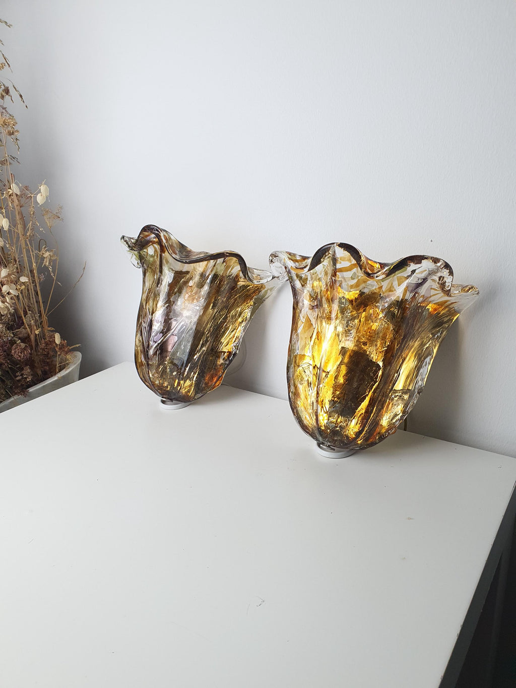 Gold-toned metal mounting base on a vintage Murano glass wall light
