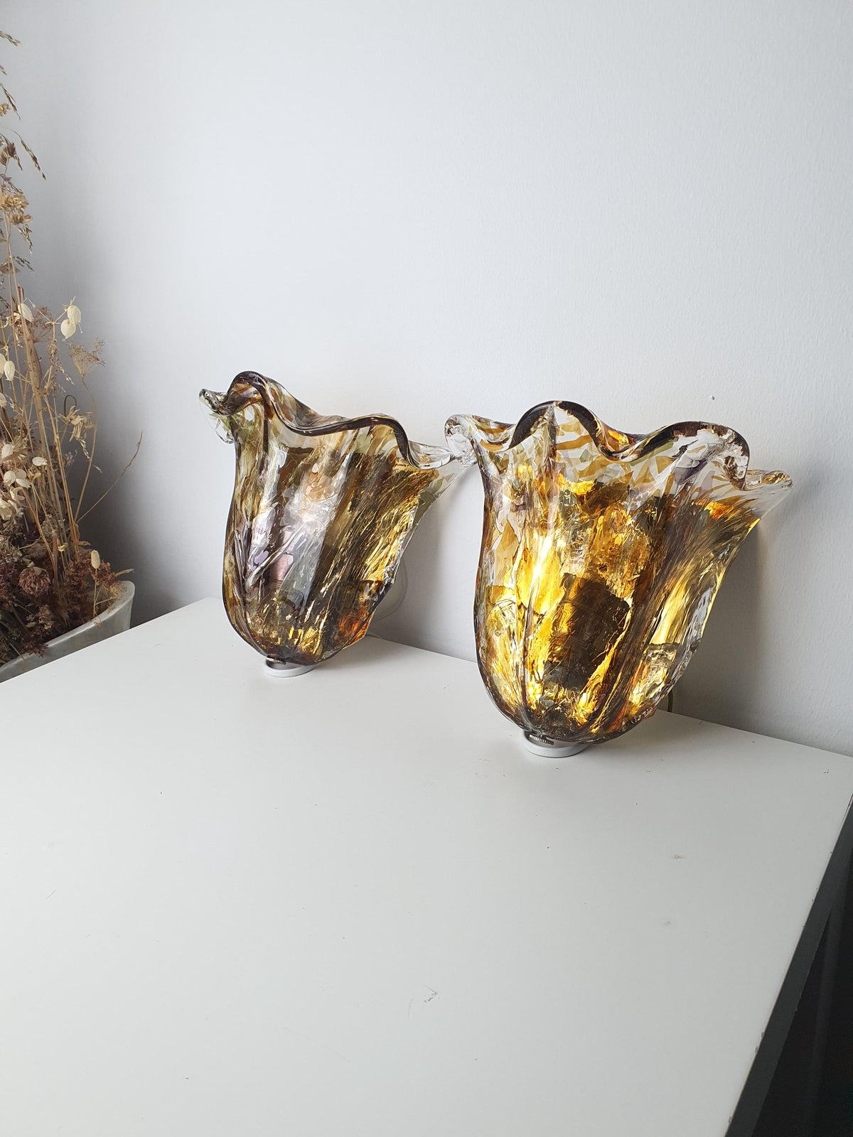 Gold-toned metal mounting base on a vintage Murano glass wall light
