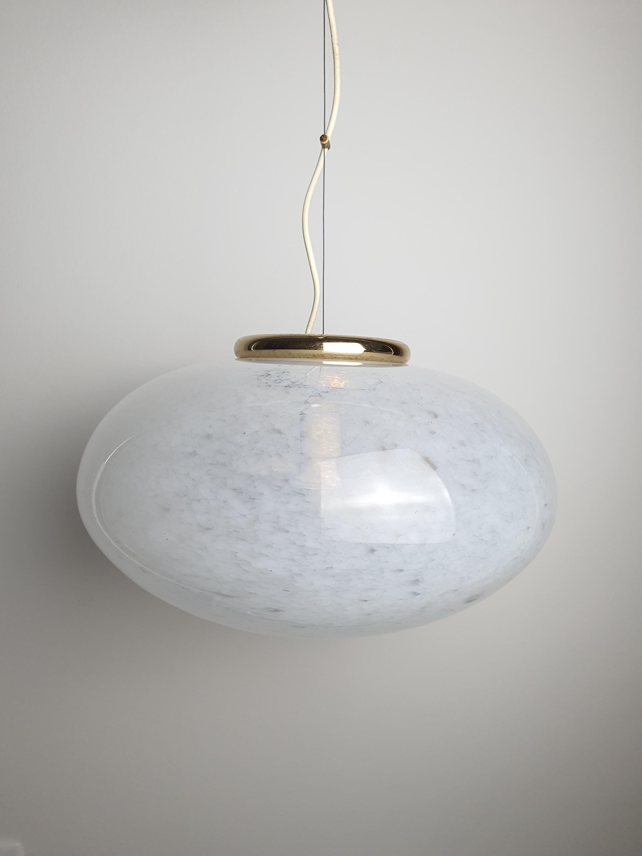 Close-up of trapped bubbles and white spots in vintage Murano glass globe shade