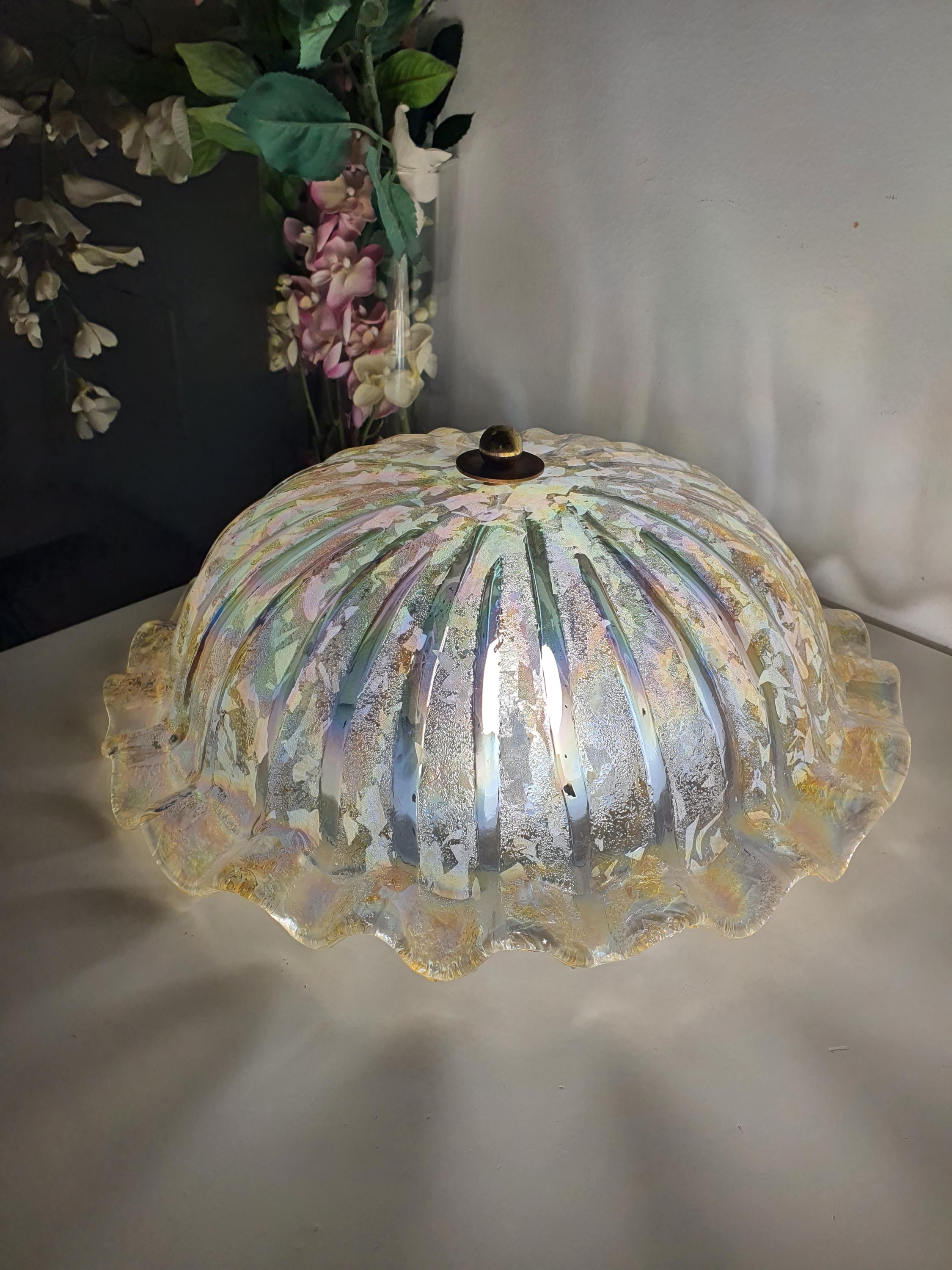 Vintage Murano iridescent shell ceiling light installed in bedroom, warm rainbow reflections, Art Nouveau organic interior