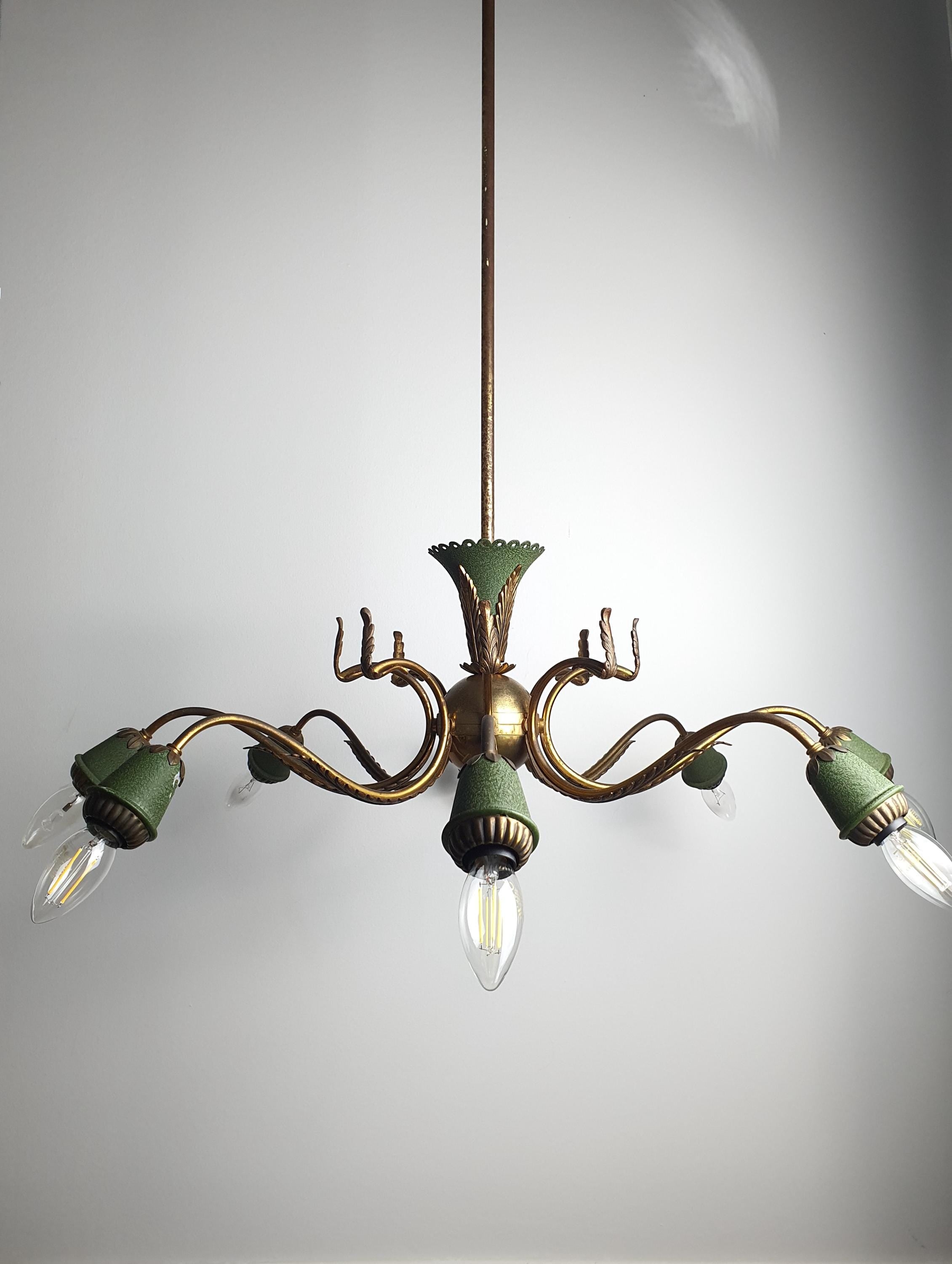 Vintage 1950s Italian 8-arm Sputnik chandelier lit, warm brass bronze glow, green leaf accents, dramatic starburst, high ceiling