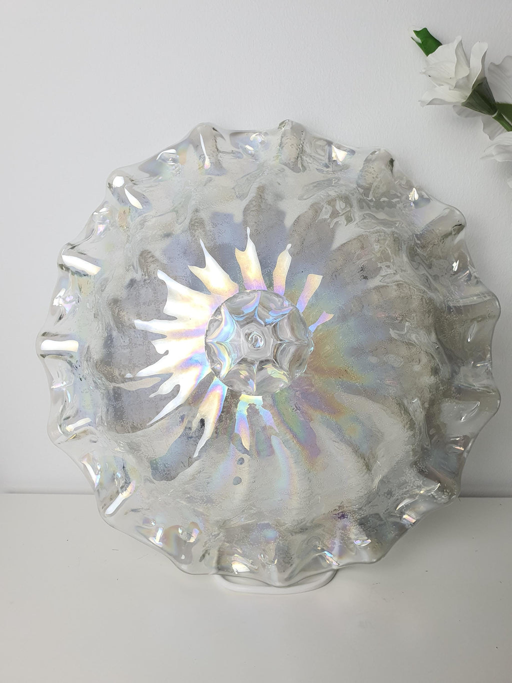 Contrasting smooth and textured surfaces on an iridescent glass shade
