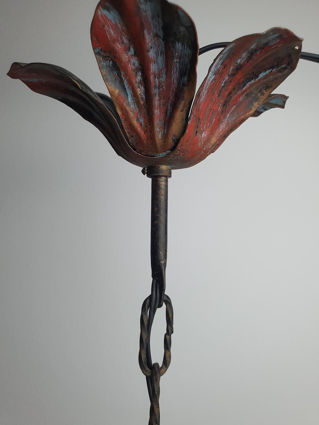 Age-related wear and patina on a vintage painted metal chandelier
