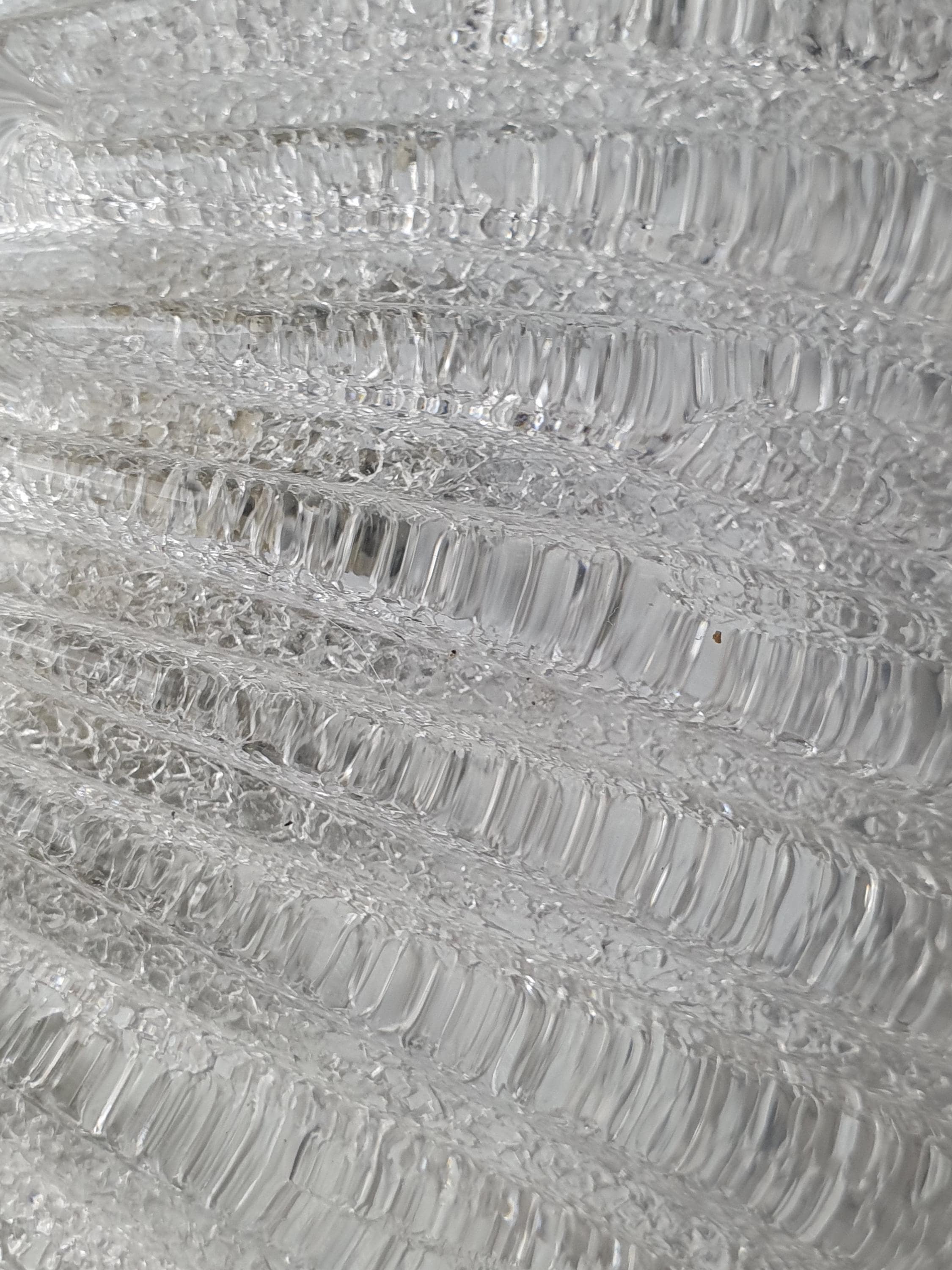 Close-up of ribbed relief pattern on vintage Venetian glass shell flush mount, smooth and glass-sand dual finish