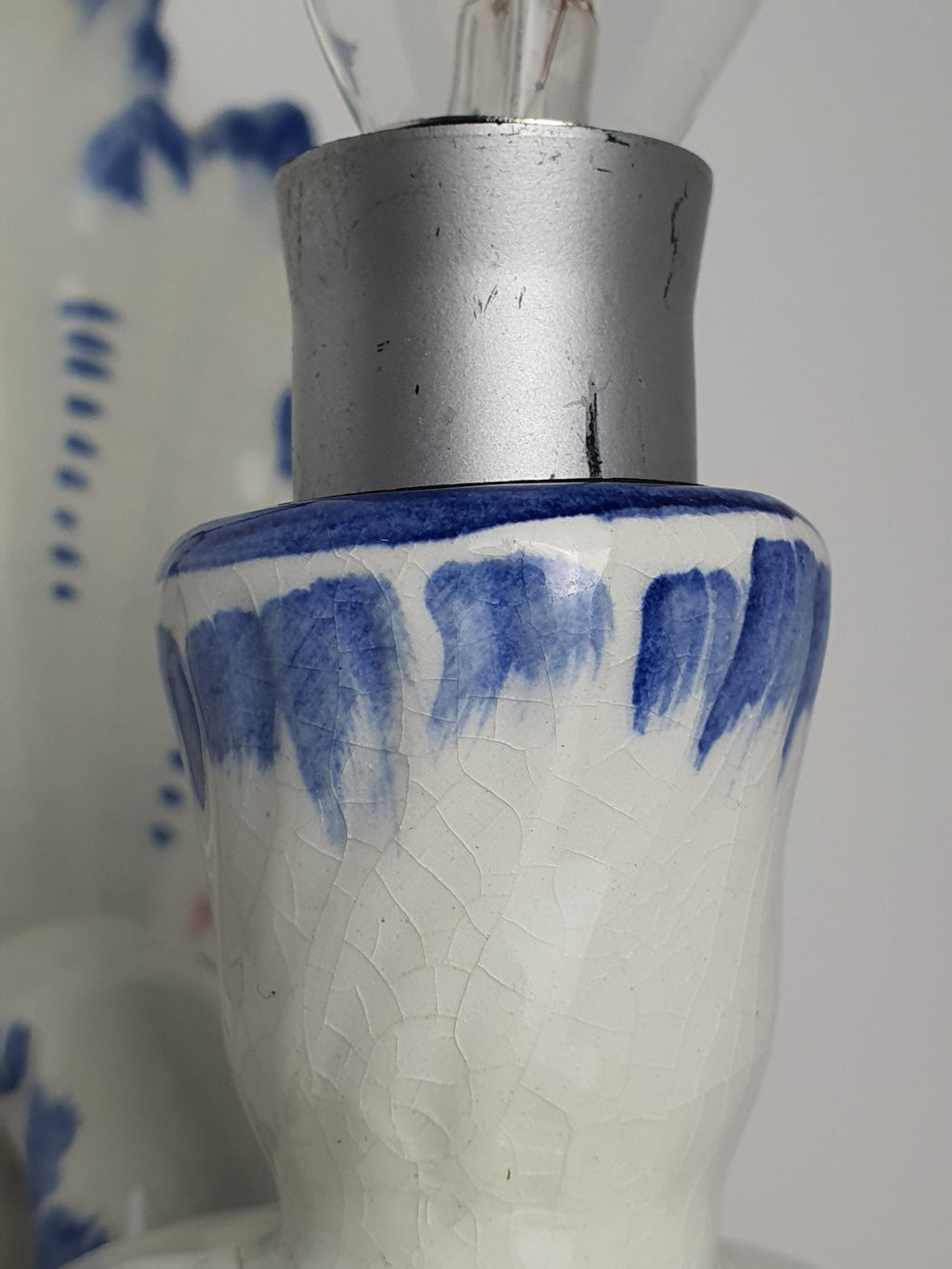 Age crazing detail on vintage Italian Bassano white glazed ceramic wall sconce, authentic vintage glaze crackling