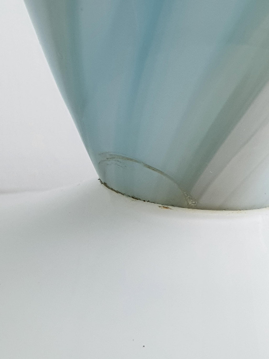 Close-up of the sky blue marbled Murano glass lamp base meeting the clear glass foot, showing the layered glass texture and a small crack near the seam.