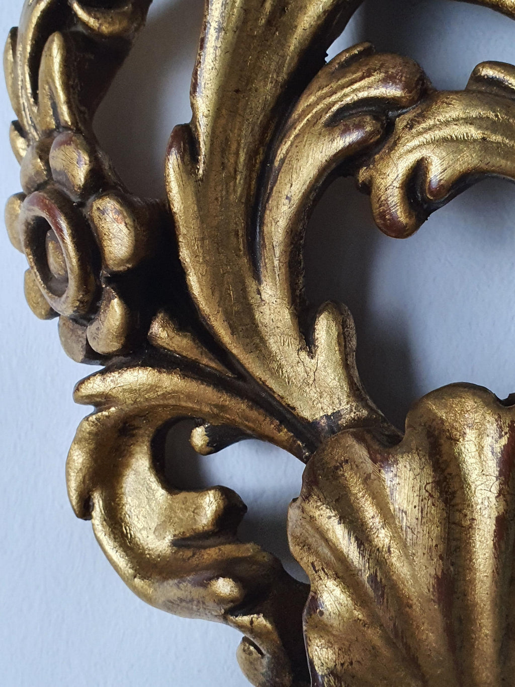 Ornate carved wooden body on a vintage Florentine wall light
