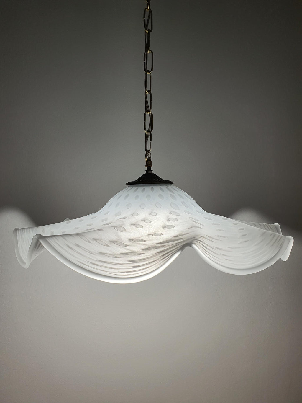 Vintage Murano glass pendant — soft warm glow through white bubbled glass, illuminated