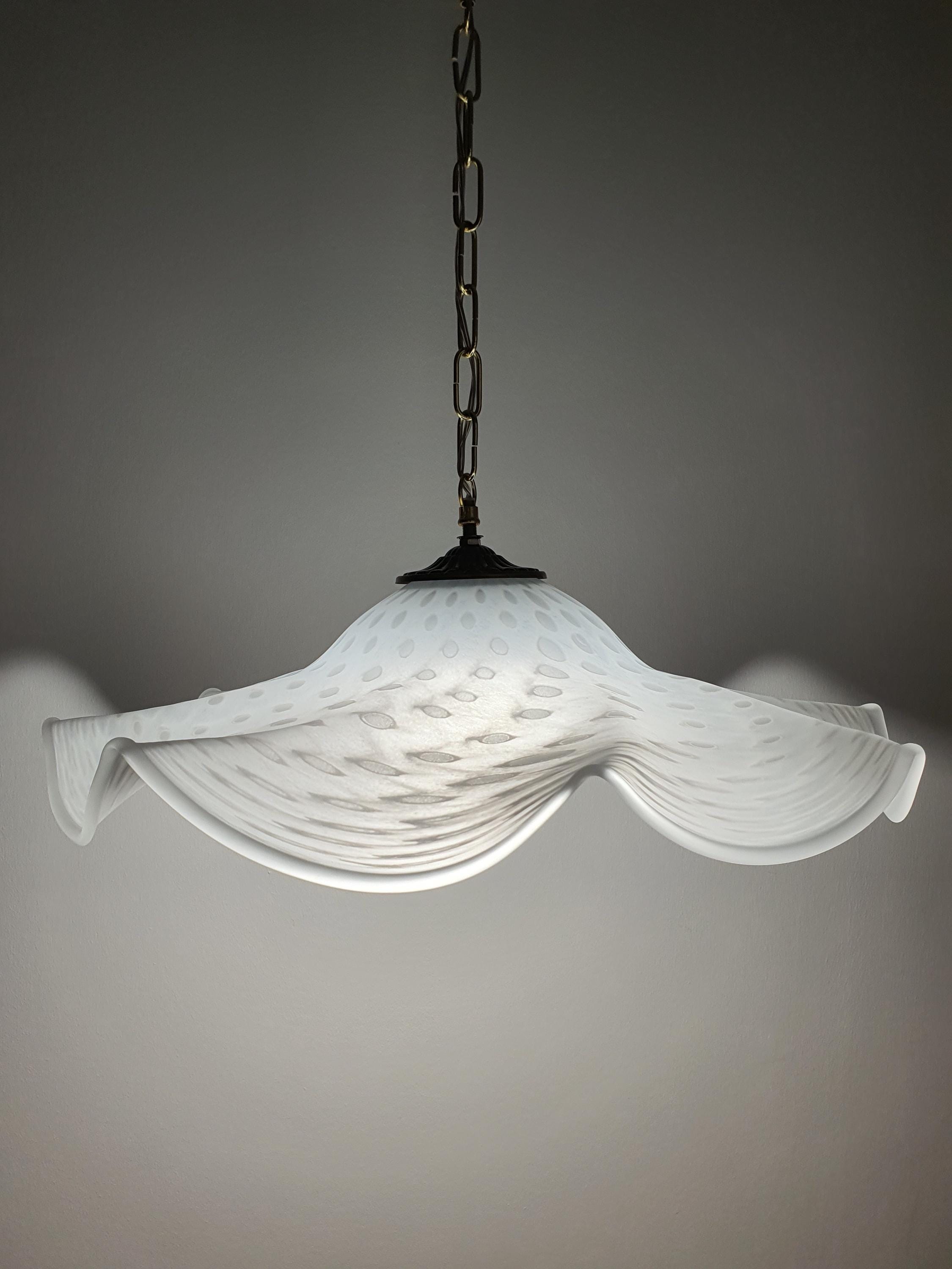 Vintage Murano glass pendant — soft warm glow through white bubbled glass, illuminated