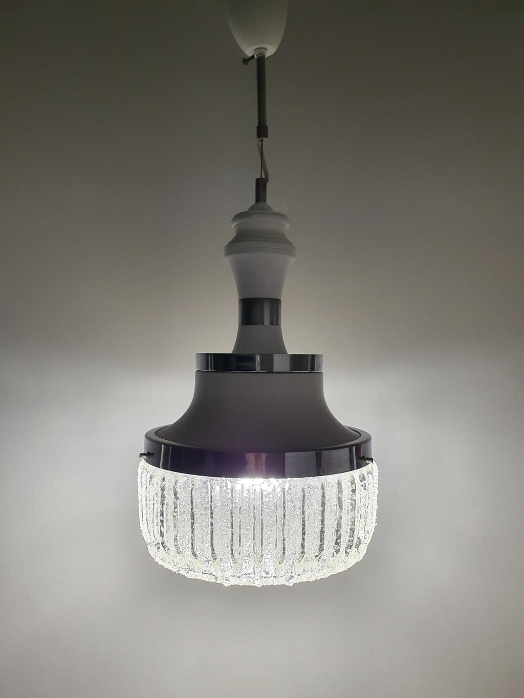 Handcrafted bubbled glass pendant — illuminated, soft diffused glow through frosted section