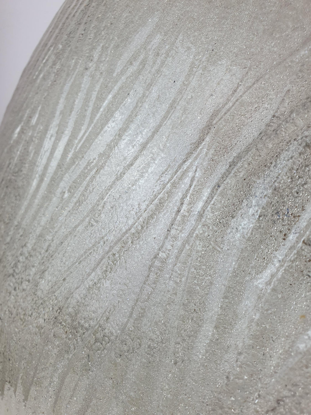 Close-up of ribbed relief pattern on vintage Venetian shell flush mount, clear glass with pronounced ribs and sparkling reflections