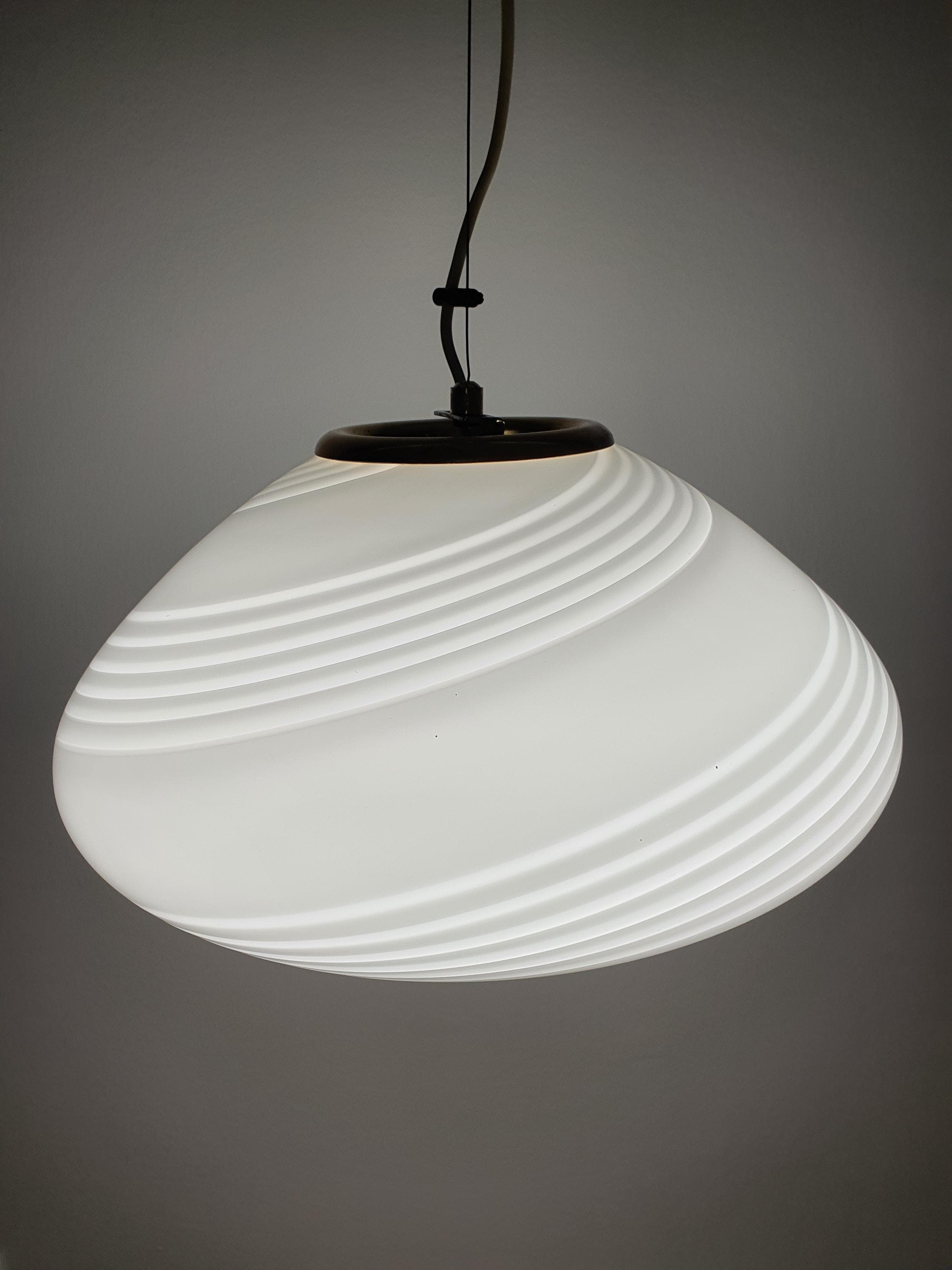 Vintage Murano white swirl oblate globe pendant above dining table, wide 40cm form, warm white glow, Scandinavian MCM interior